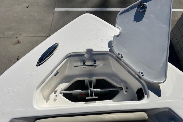 Open anchor compartment on 2026 Key West 239 FS boat, showcasing storage space.