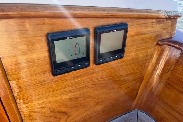 Wooden dashboard with Garmin navigation displays on a 2006 Morris 36 boat.