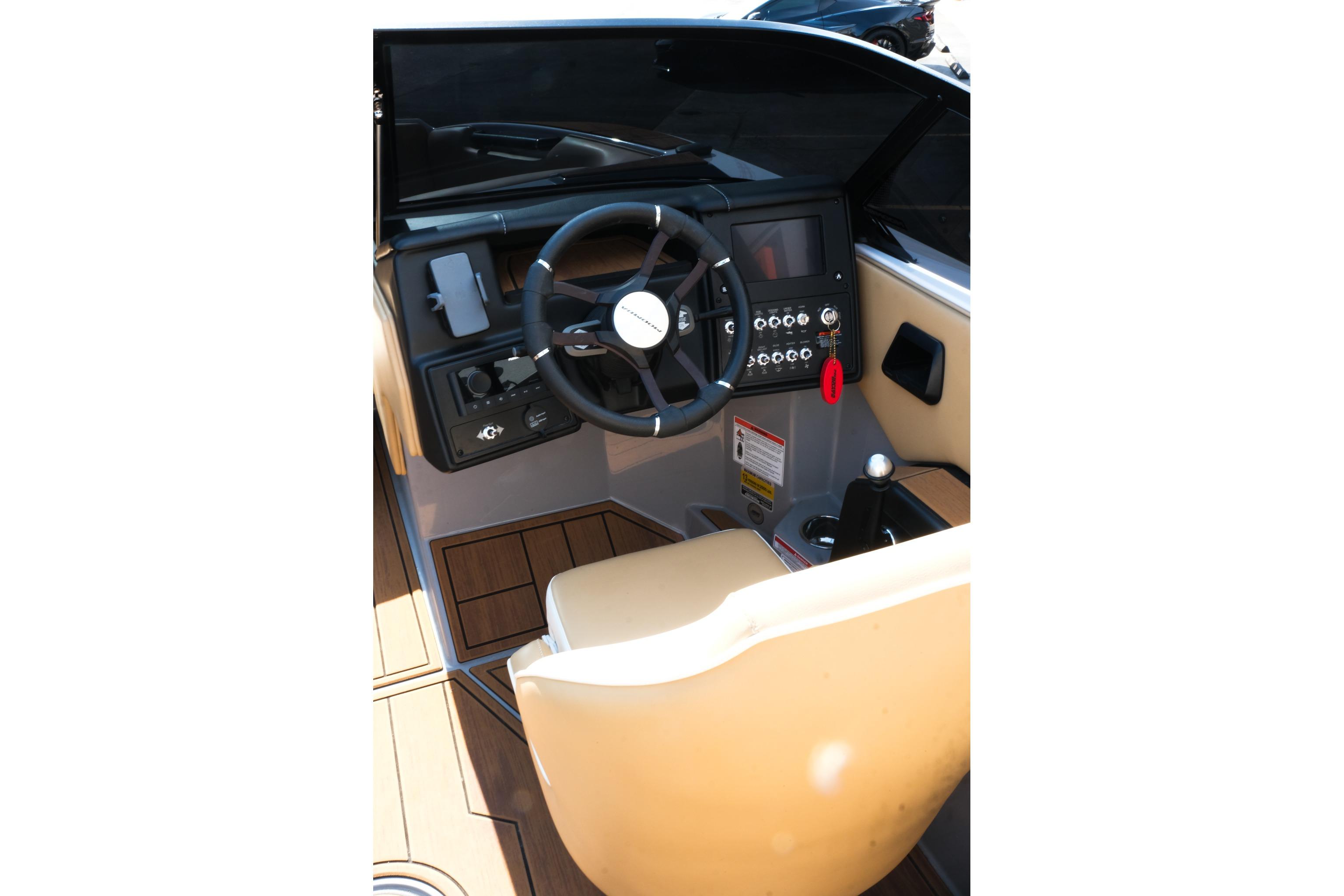 2023 Moomba Mondo boat cockpit with steering wheel and control panel.