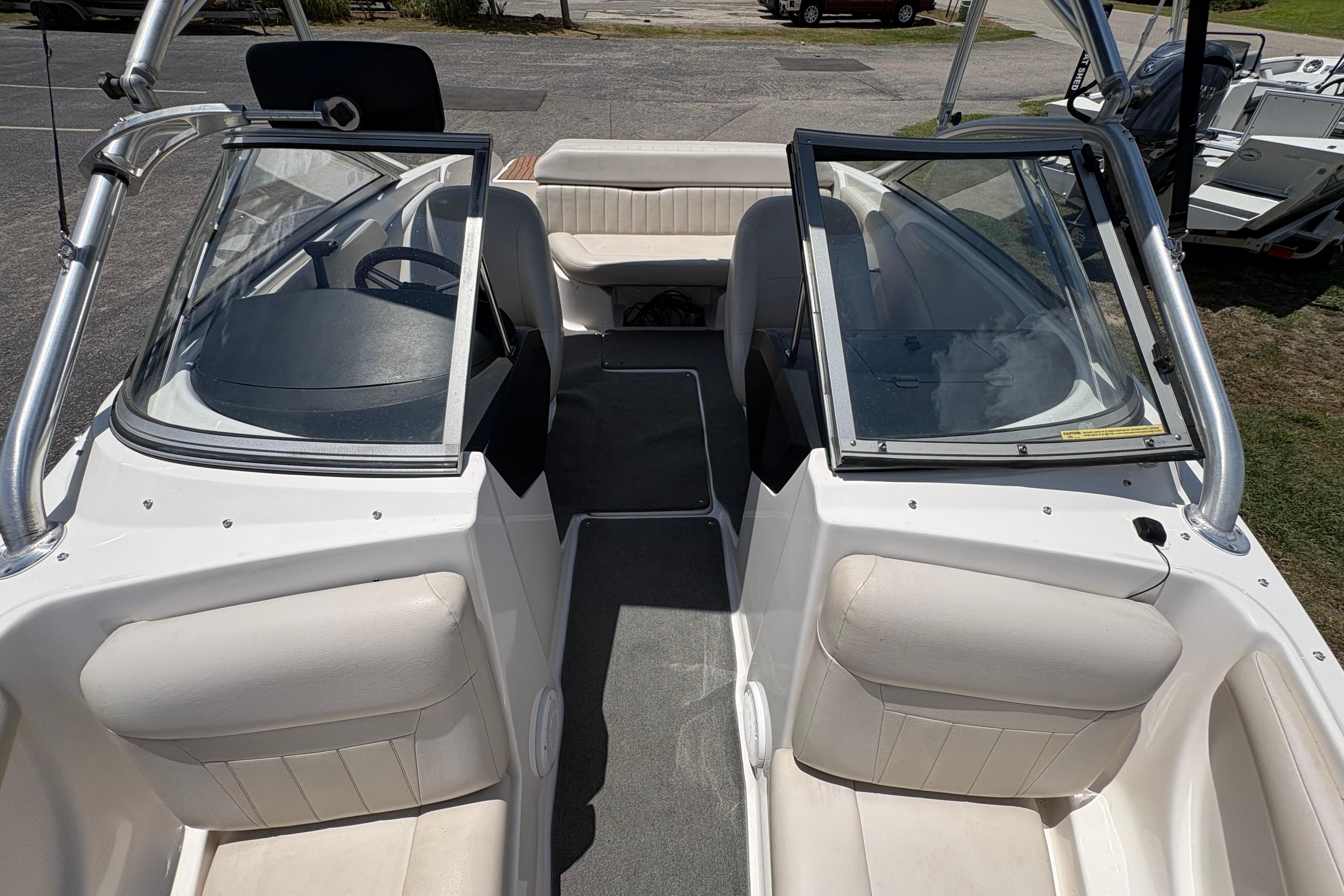 2008 Regal 1900 Bowrider interior with seating and steering wheel, parked outdoors.