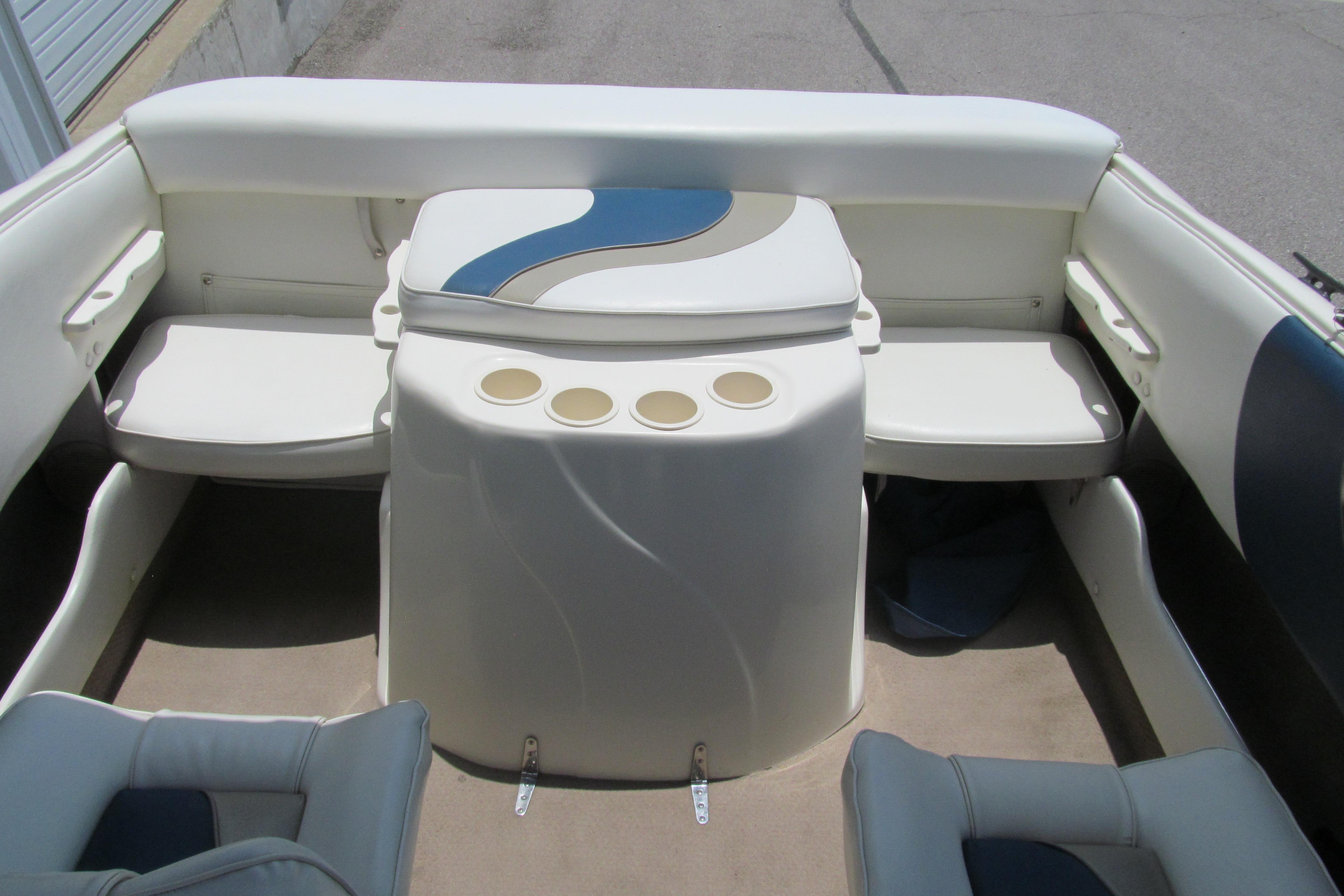 Interior of a 2000 Rinker boat featuring seating and cup holders.
