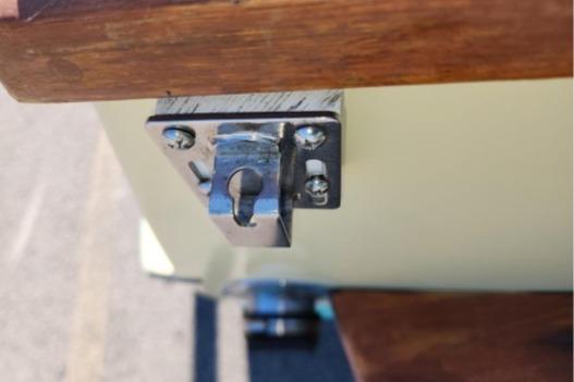 Close-up of a metal latch on a 1985 Wasque Down East Cruiser boat.