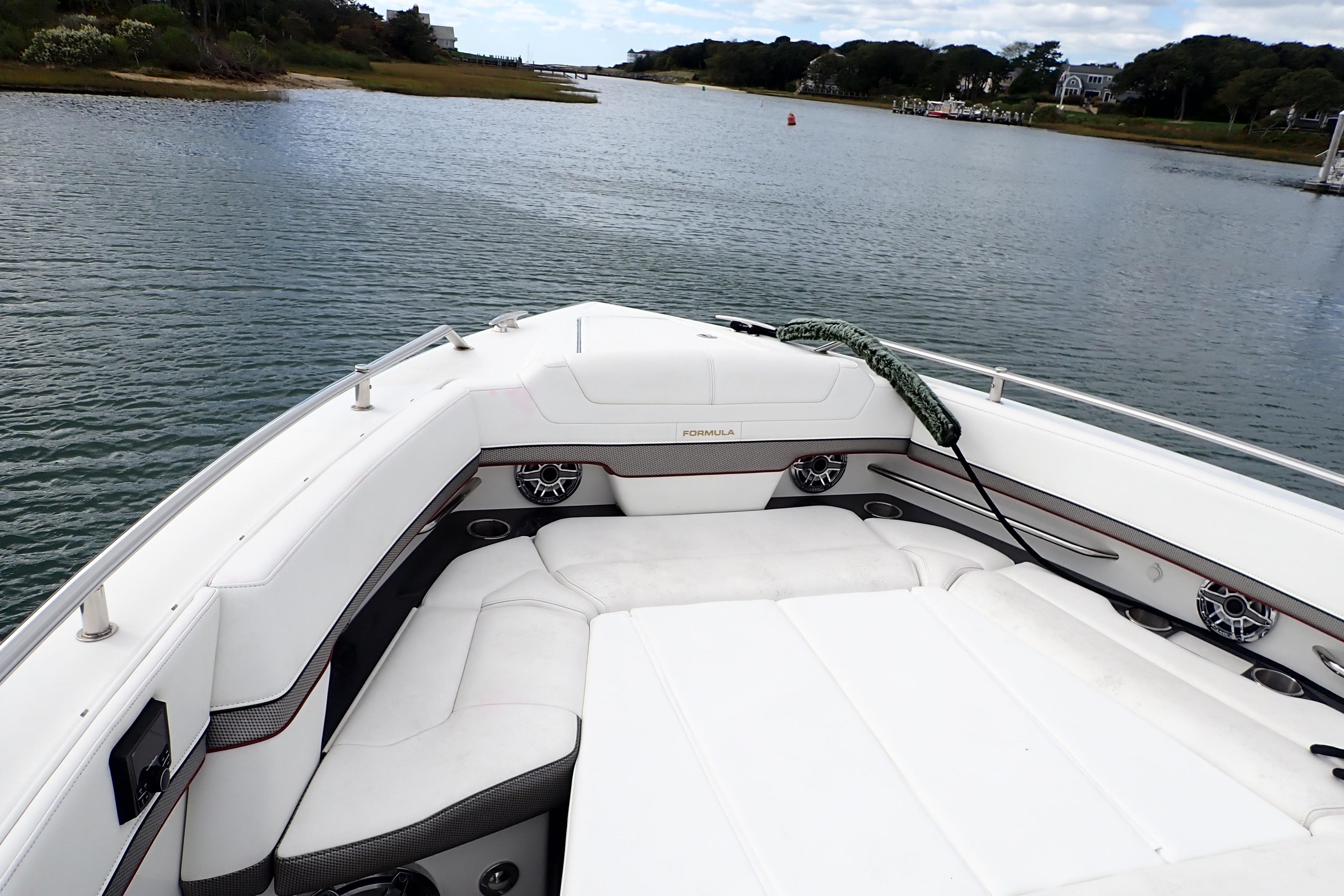 2022 Formula 380 Super Sport Crossover OB boat on calm water, featuring luxurious seating.
