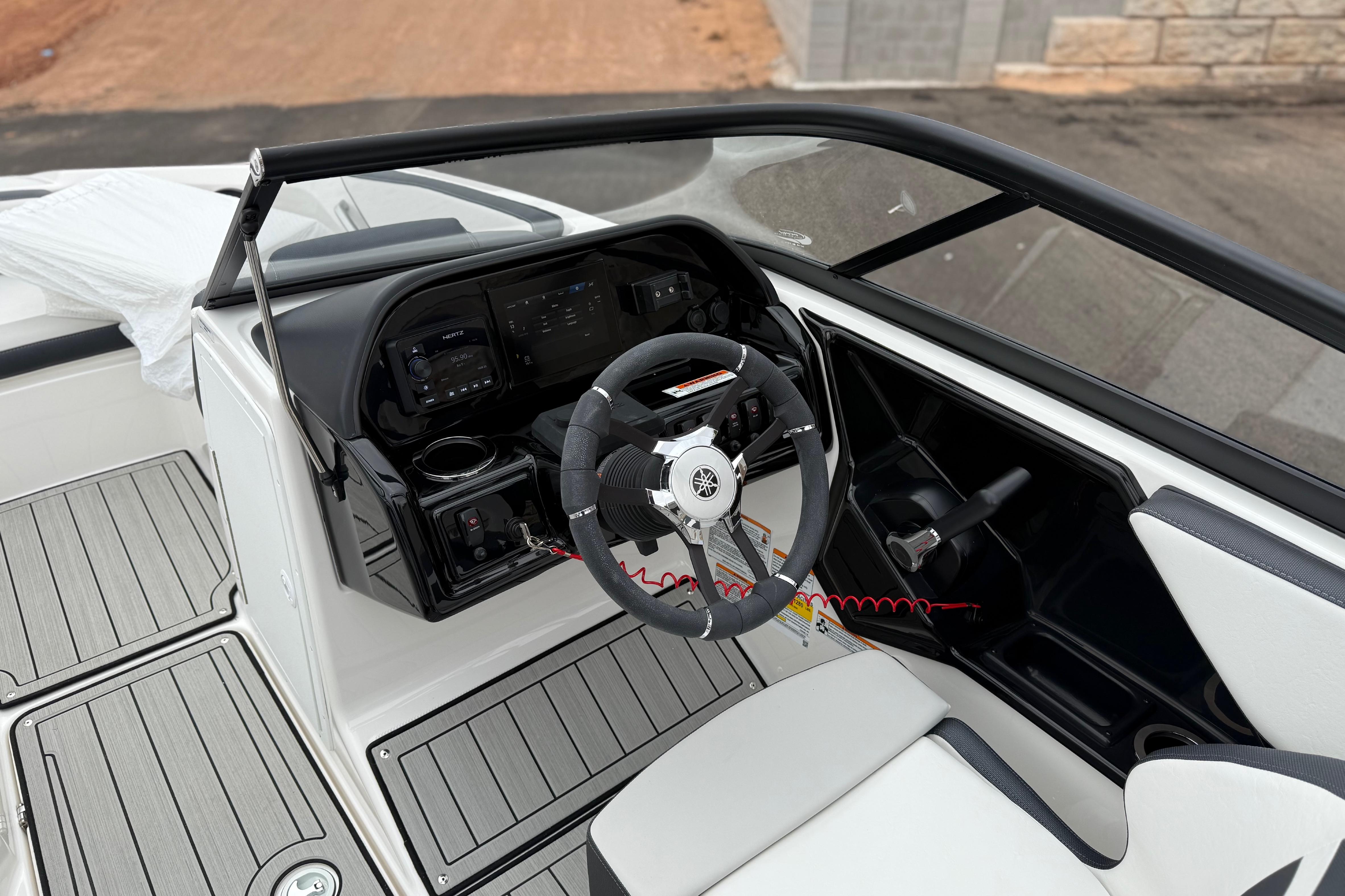 2025 Yamaha Boats 195S interior with sleek dashboard and modern steering wheel design.