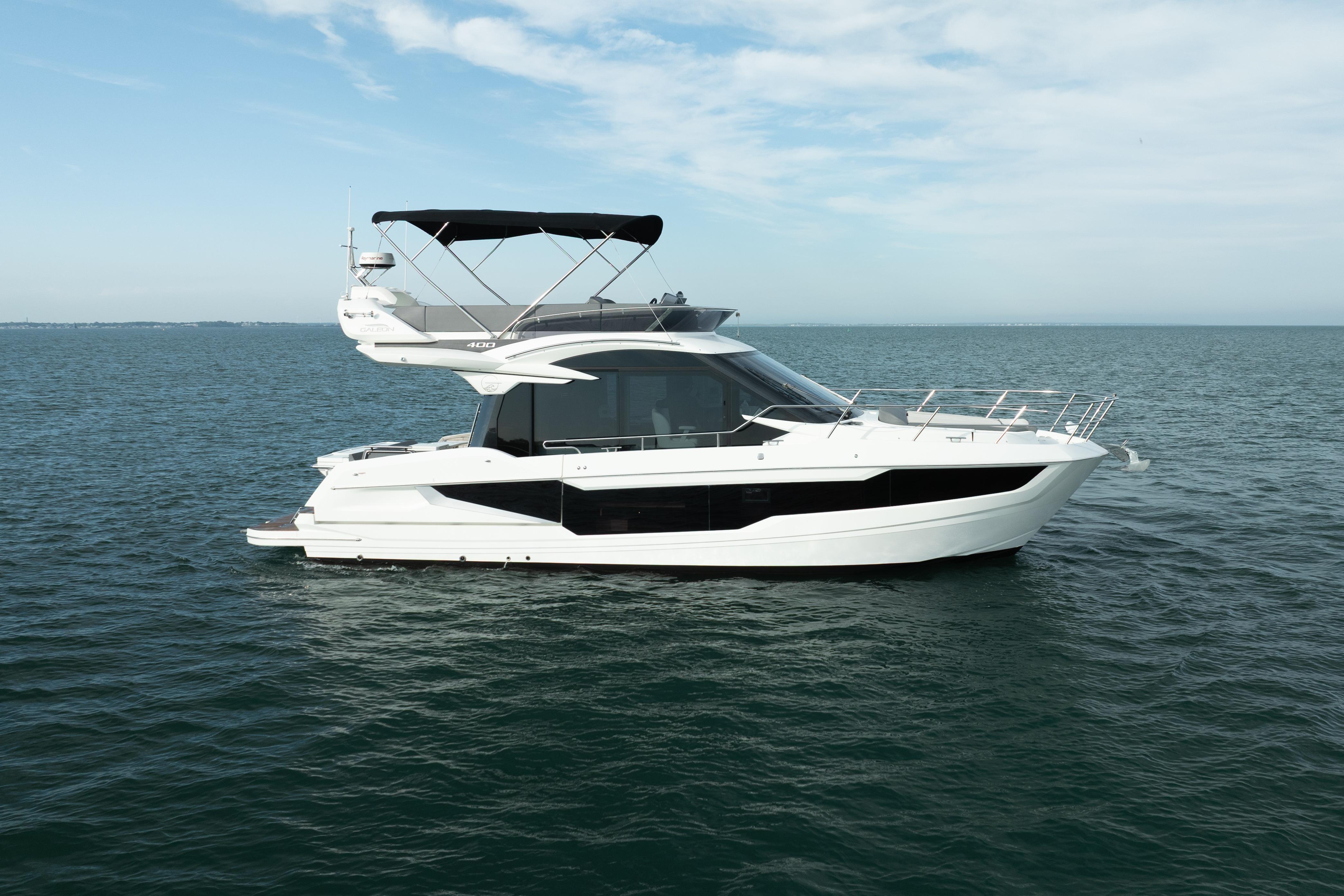 2023 Galeon 400 Fly yacht cruising on open water under a clear sky.