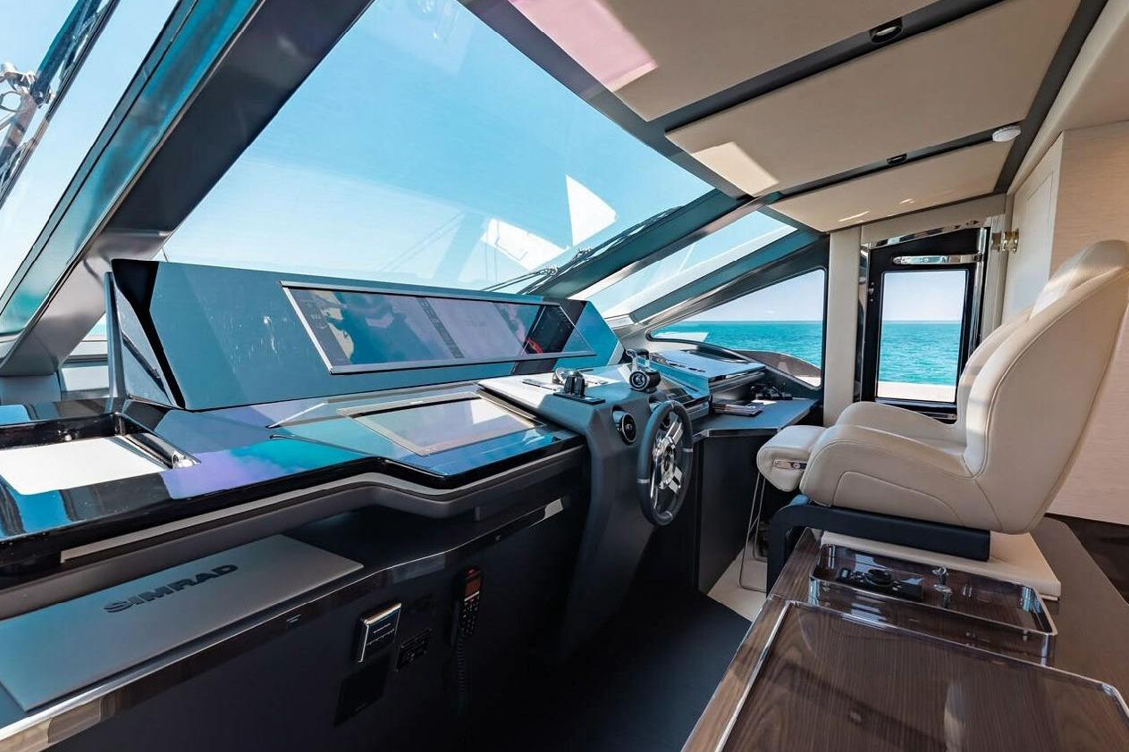 Luxurious 2022 Azimut S10 yacht cockpit with modern controls and panoramic ocean view.