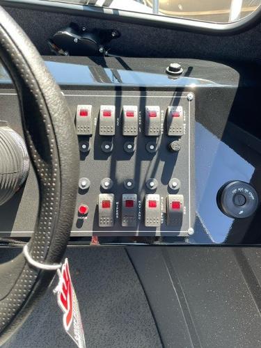 Dashboard of 2024 Spartan 220 Maximus with control switches and steering wheel.