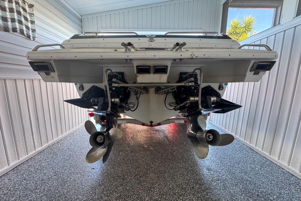 1989 Formula 292 SR-1 boat in garage, showcasing dual propellers and sleek design.