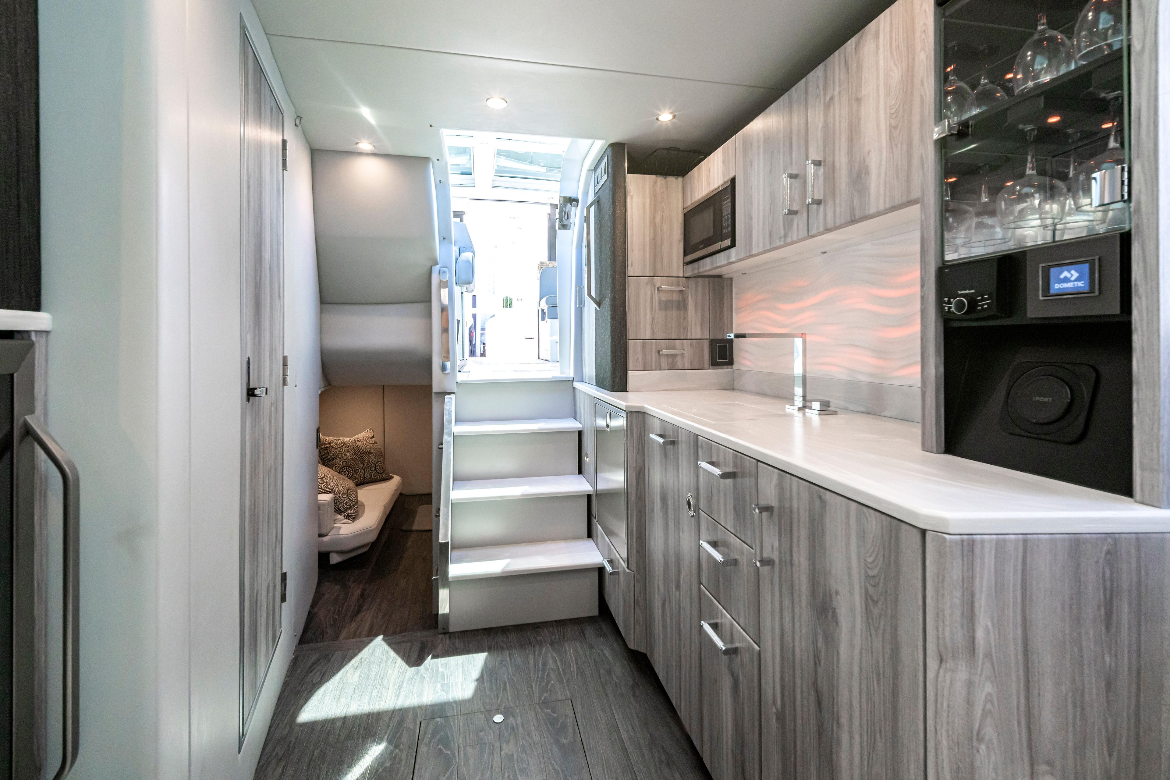 Interior of 2022 Formula 500 Super Sport Crossover with modern kitchen and seating area.