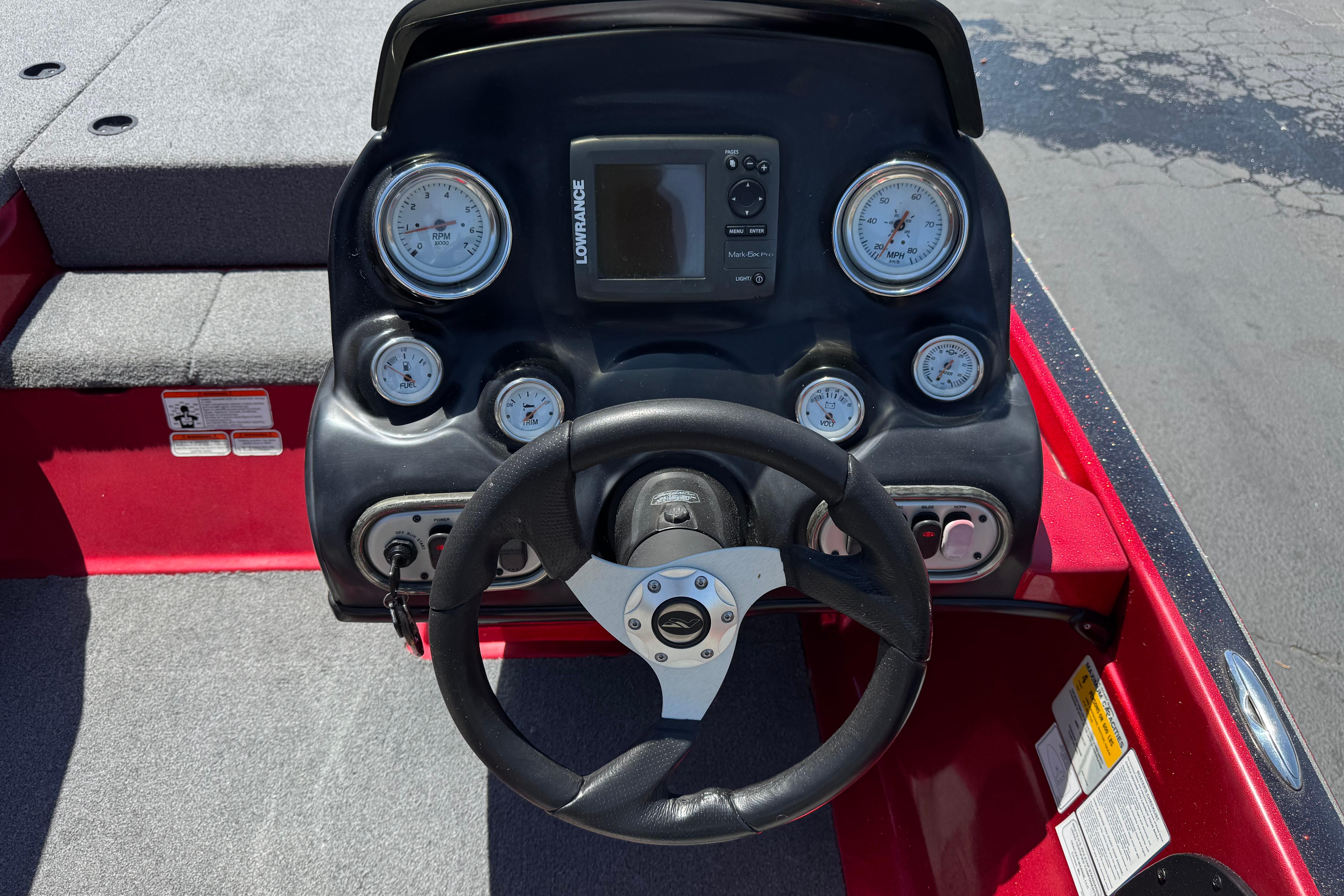 Steering console of a 2012 Nitro Z-7 boat with gauges and Lowrance display.
