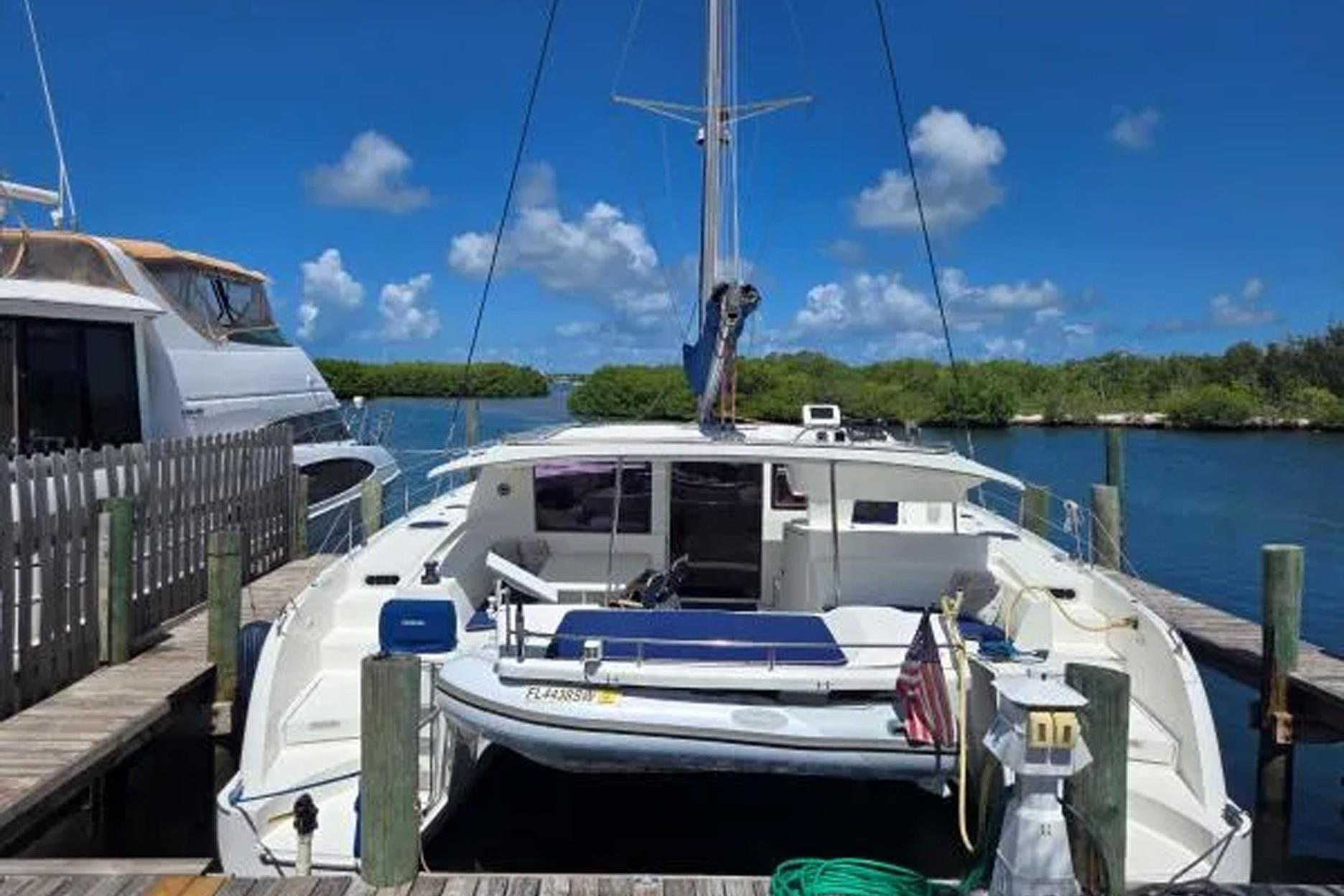 2008 Fountaine Pajot Salina 48 catamaran docked in a scenic marina.