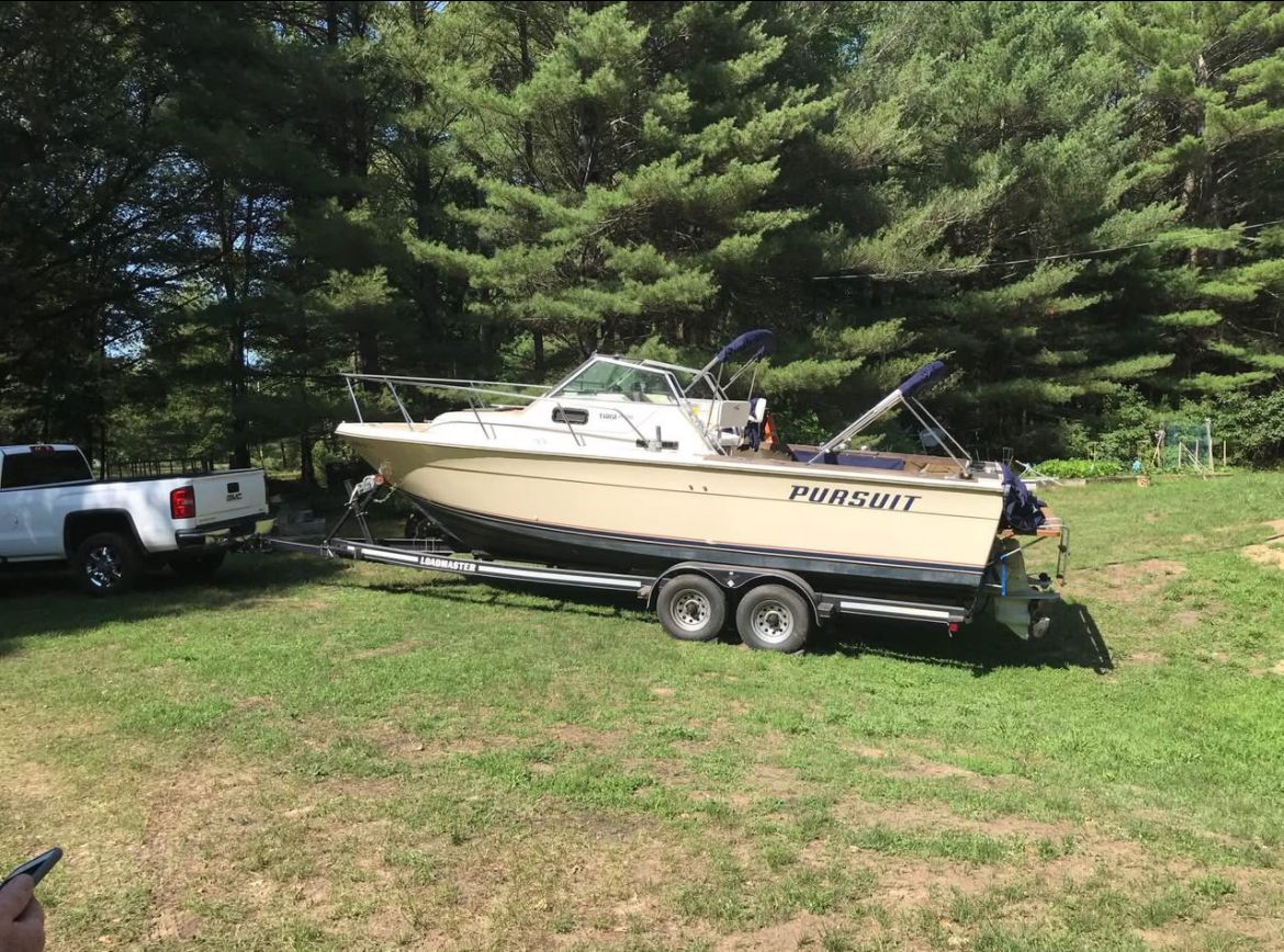 1984 Tiara Yachts PURSUIT 2600 on trailer in grassy area.