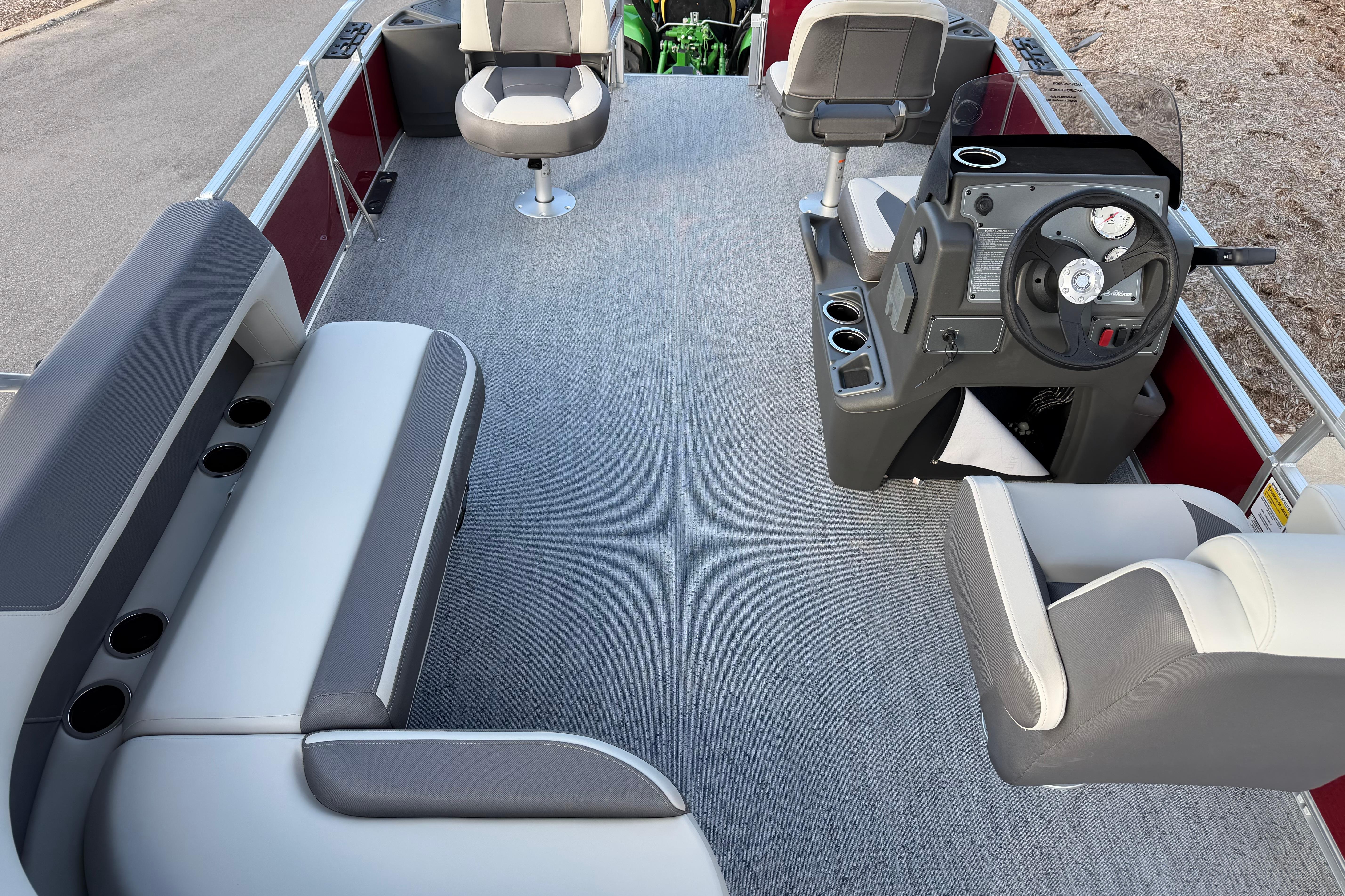 Interior of 2026 Sun Tracker Bass Buggy 18 DLX pontoon boat with seating and steering console.