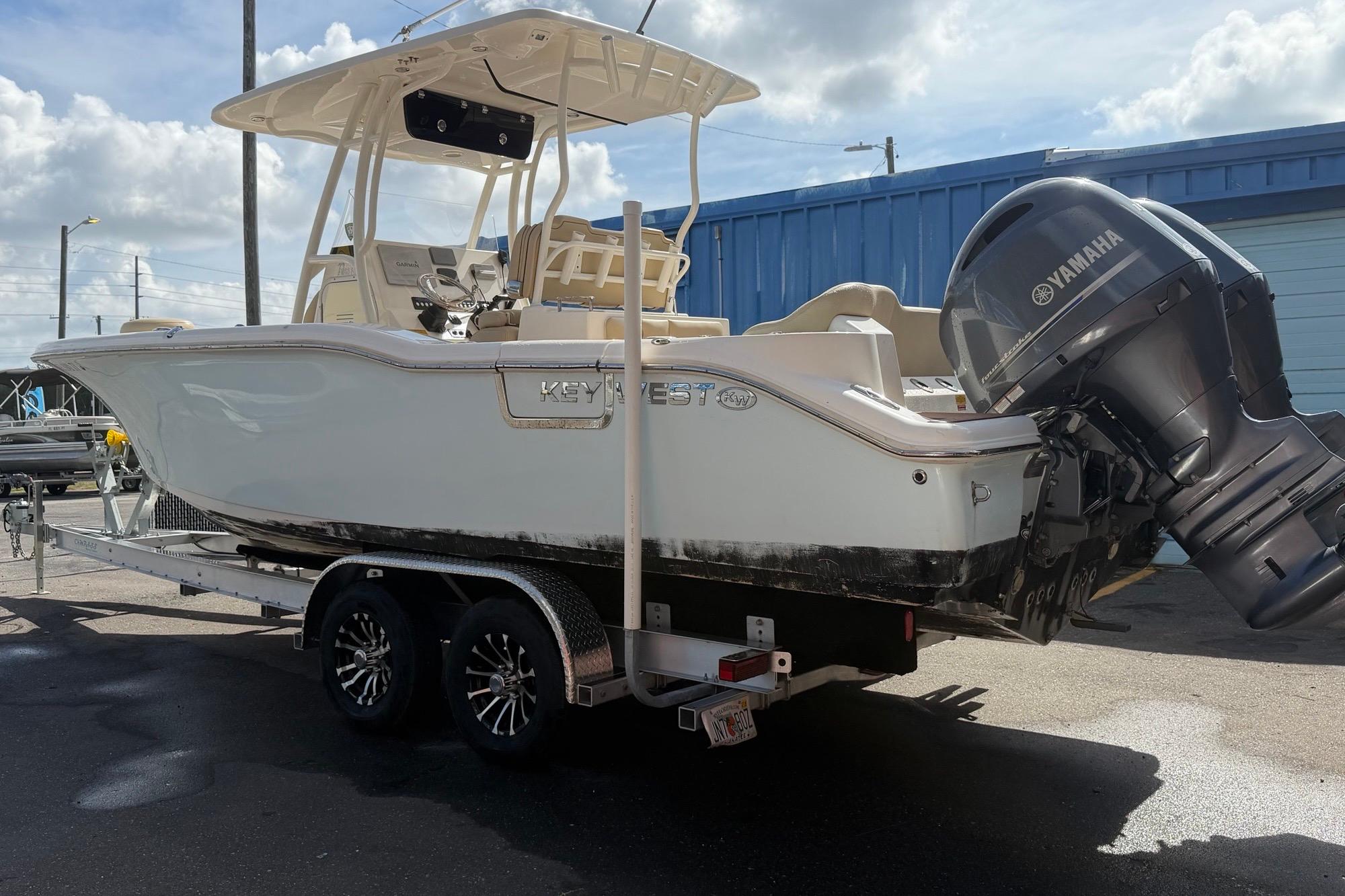 2019 Key West 263 FS boat with Yamaha engine on trailer, parked outdoors.
