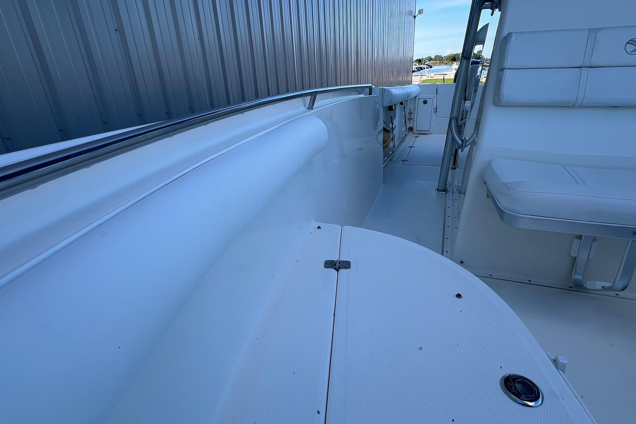 2006 Edgewater 245CC boat interior with white seating and stainless steel railing.