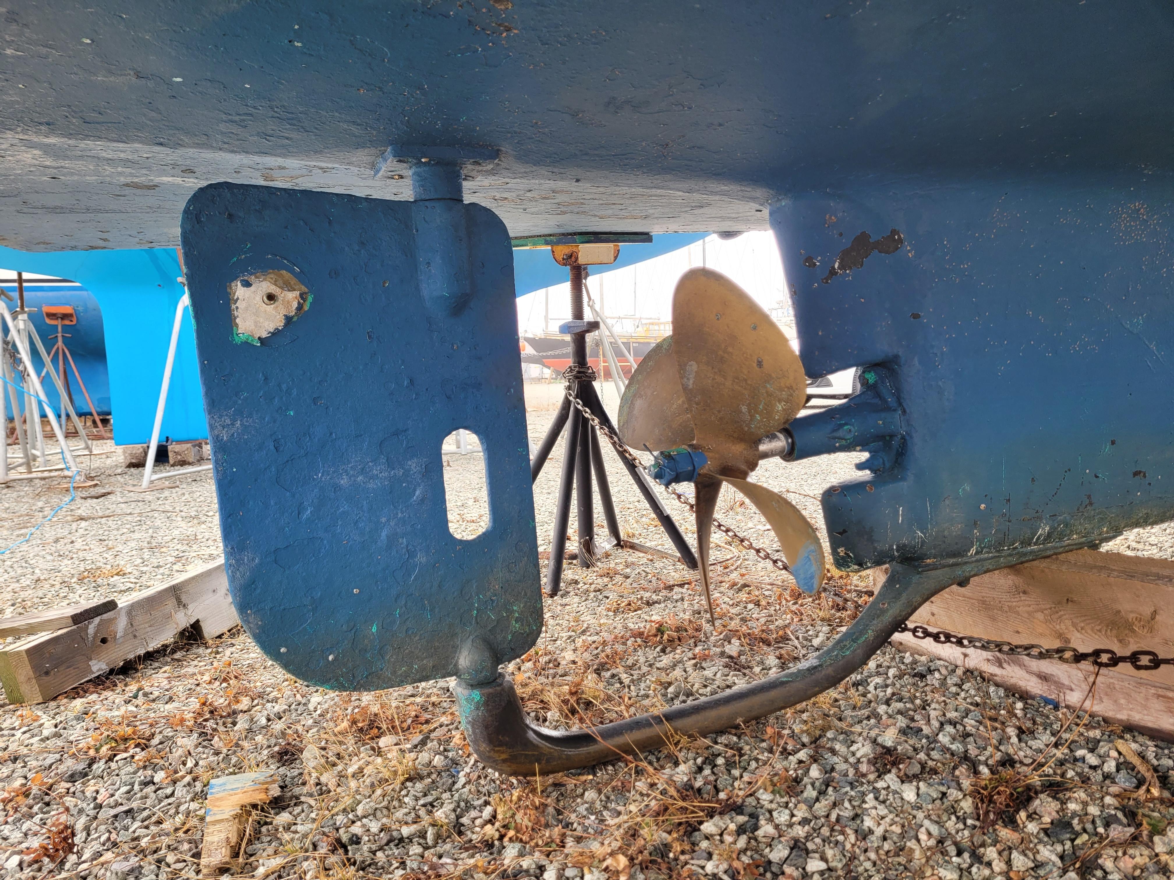 1981 Mainship 34 Trawler propeller and rudder on gravel, dry docked.