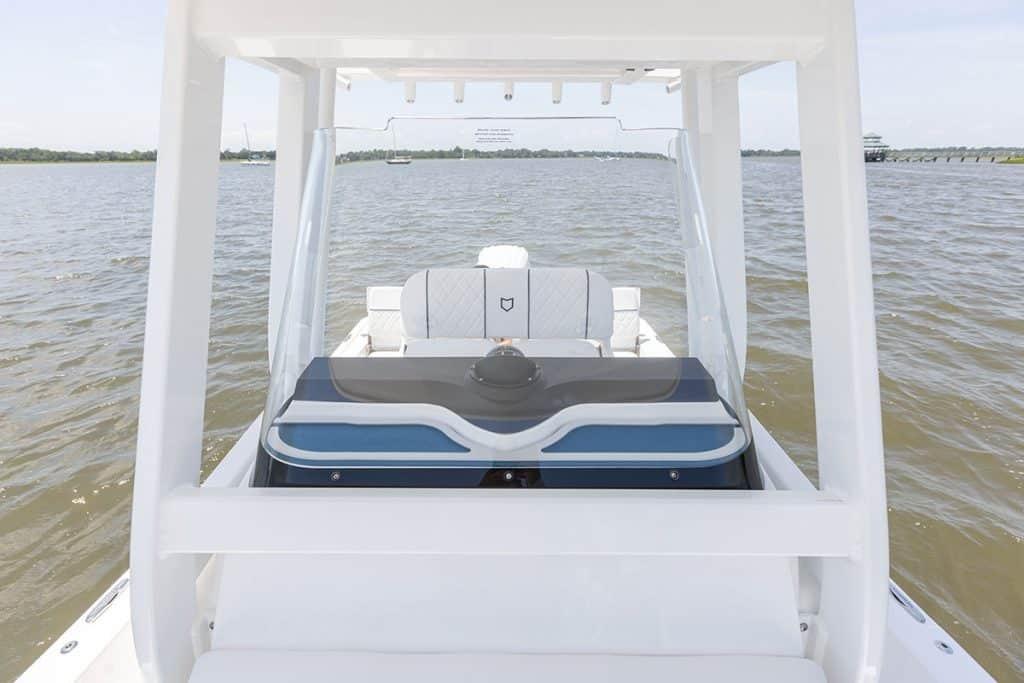 2027 Sea Fox 231 Bay Fox boat on calm water, featuring sleek design and spacious seating.