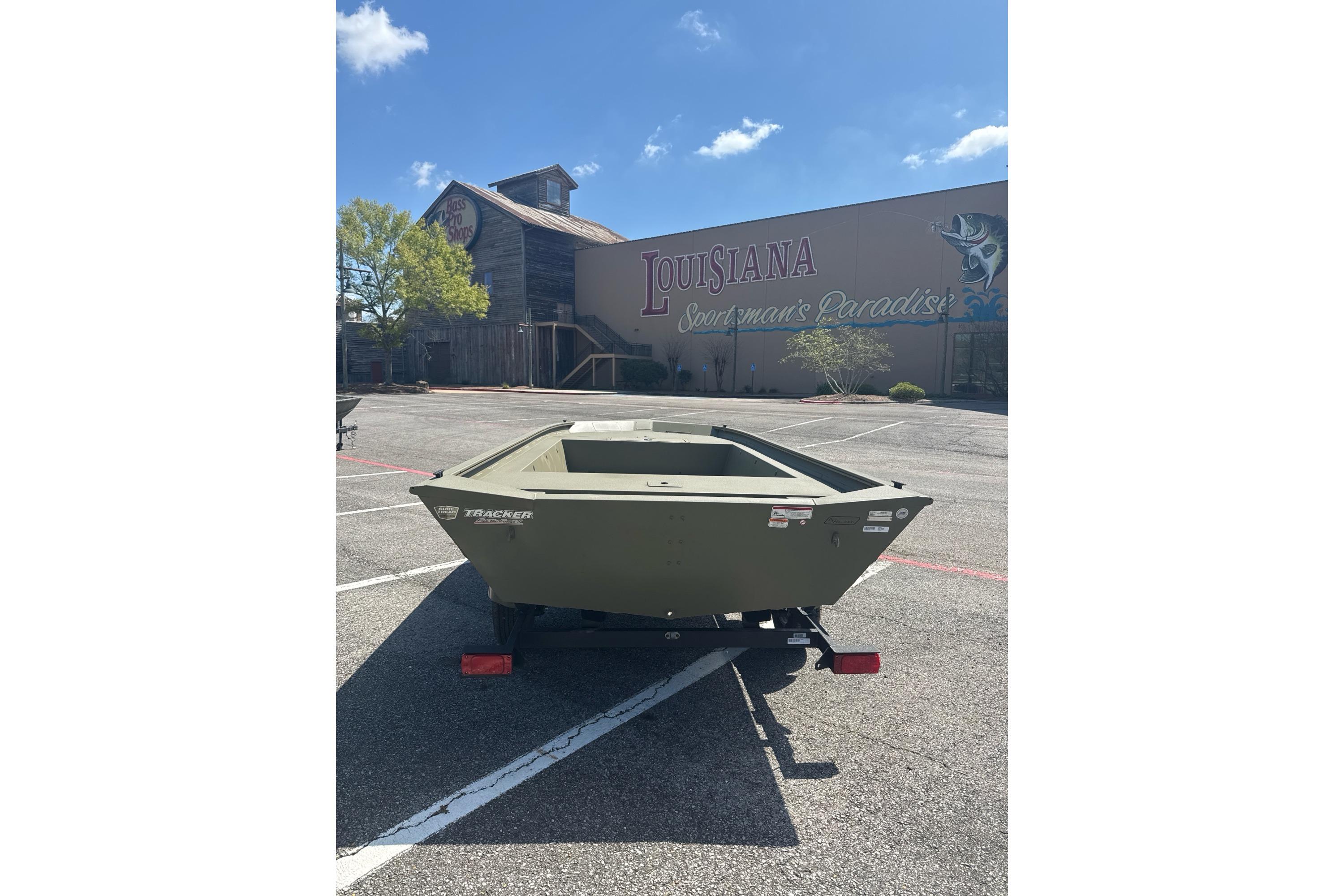 2026 Tracker Grizzly 1754 Utility boat in parking lot, Louisiana Sportsman's Paradise backdrop.