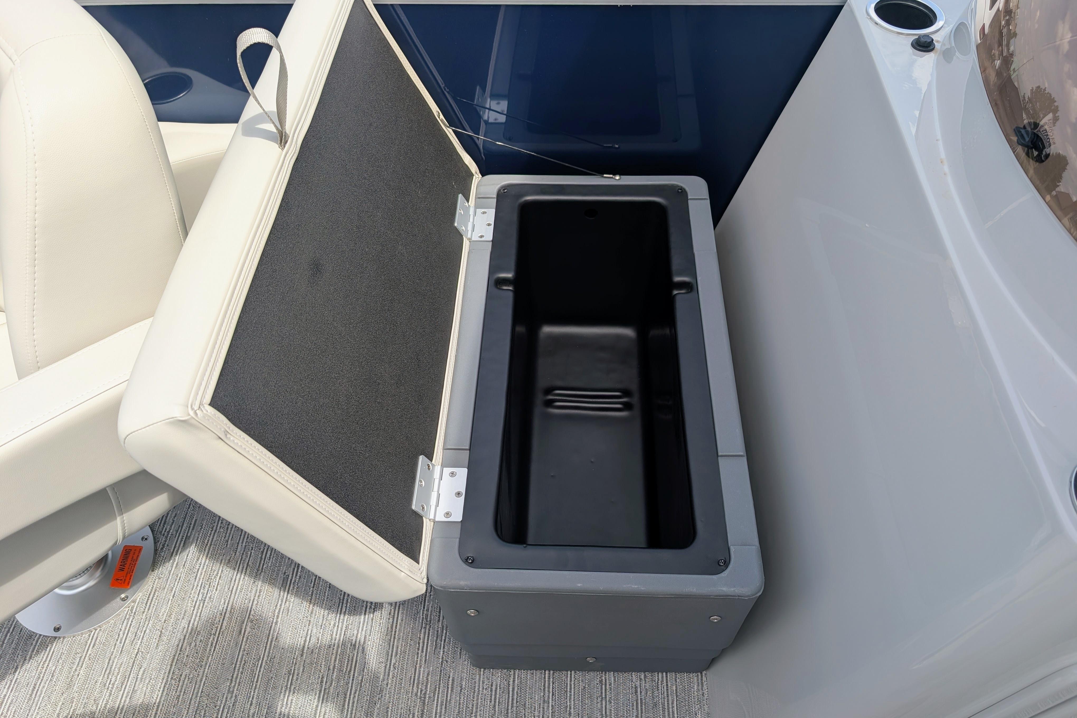 Open storage compartment on 2026 Starcraft EX 20 F boat, featuring cushioned seating.