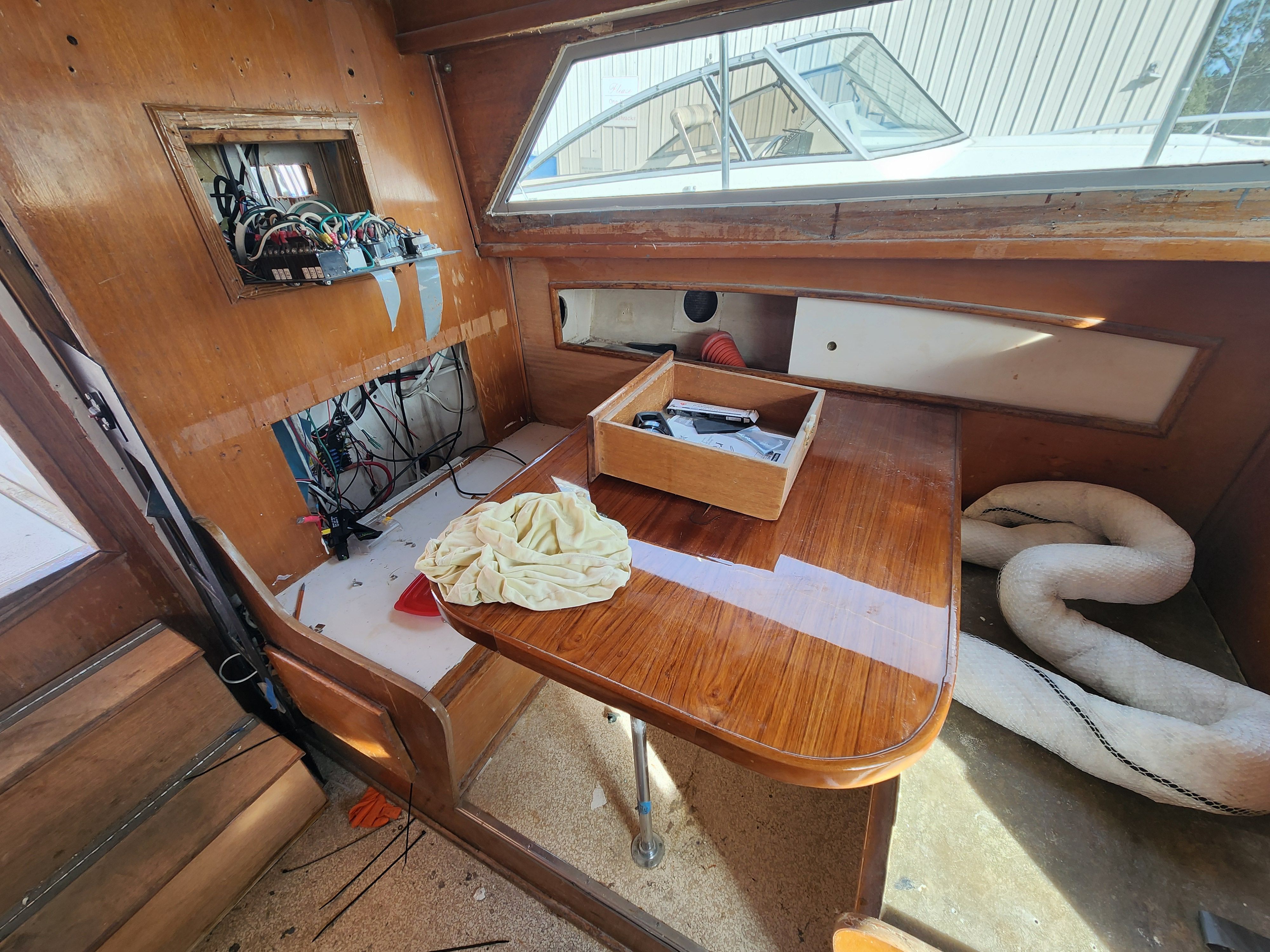 Interior of a 1967 Hatteras 28ft yacht with wooden table.