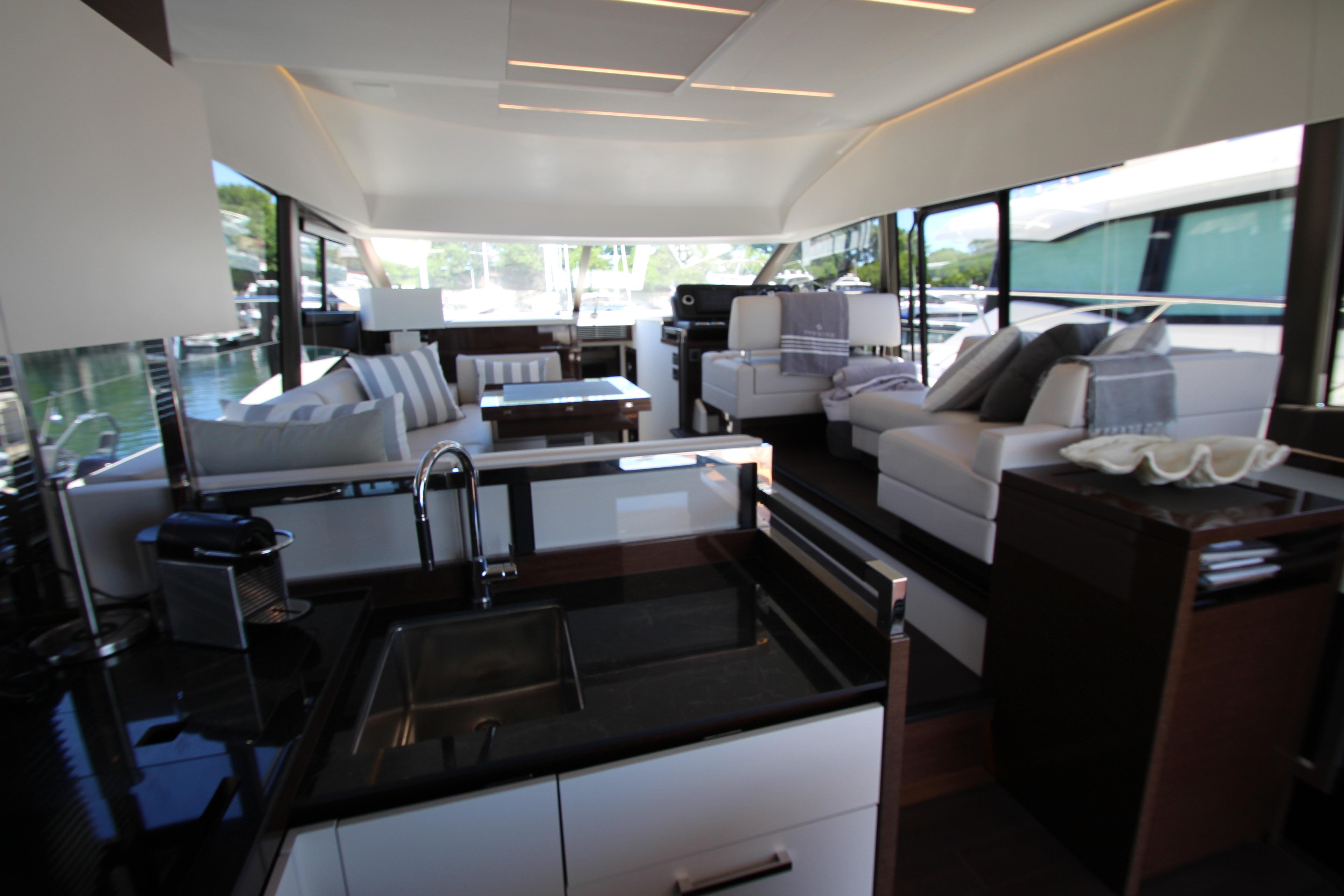 Luxurious interior of 2022 Prestige 520 yacht with modern furnishings and sleek design.
