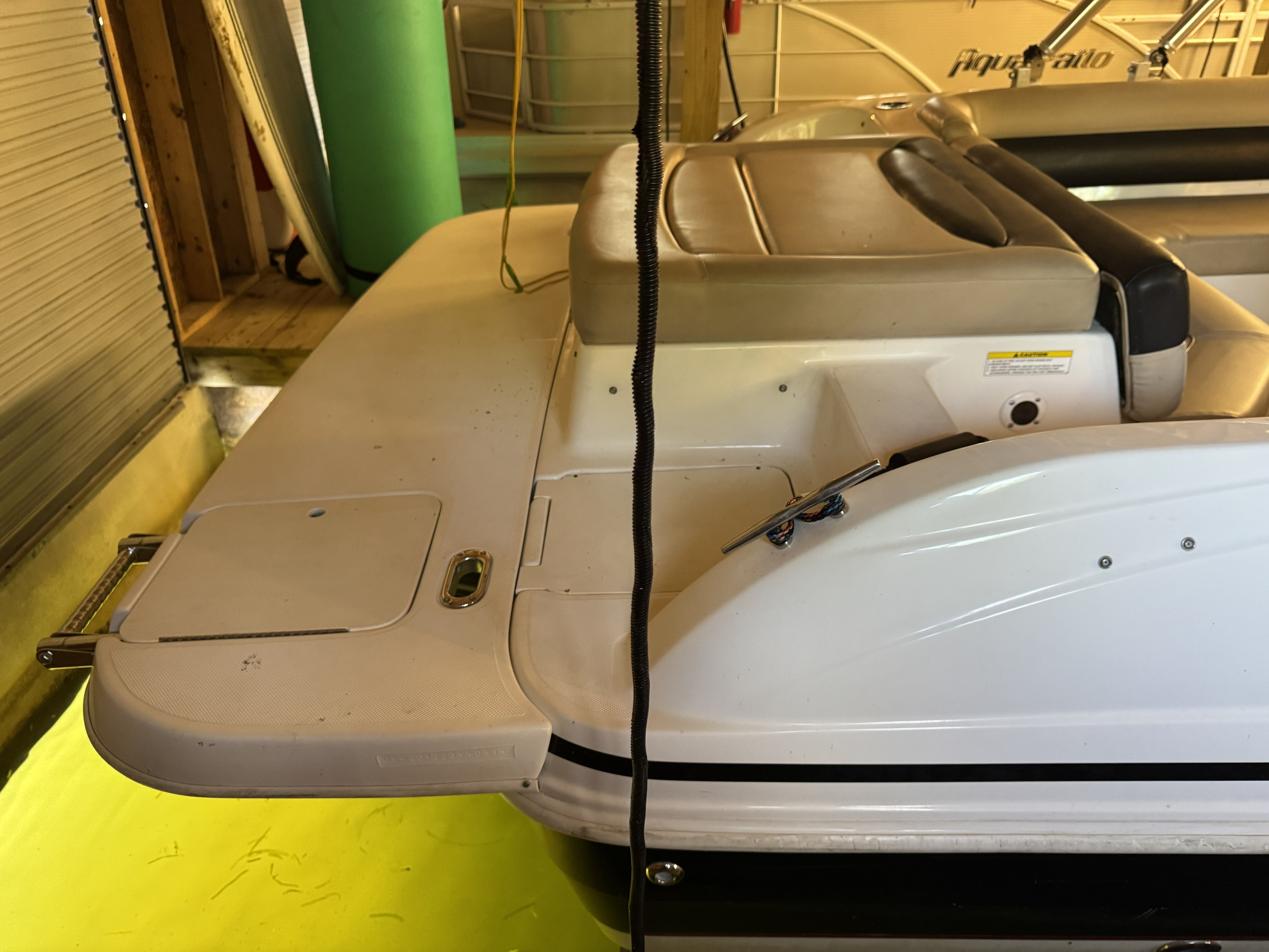 The image shows the stern of a 2014 Hurricane SS201 I/O boat in a storage facility.