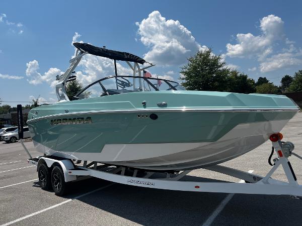 2025 Moomba Max boat on trailer under blue sky.