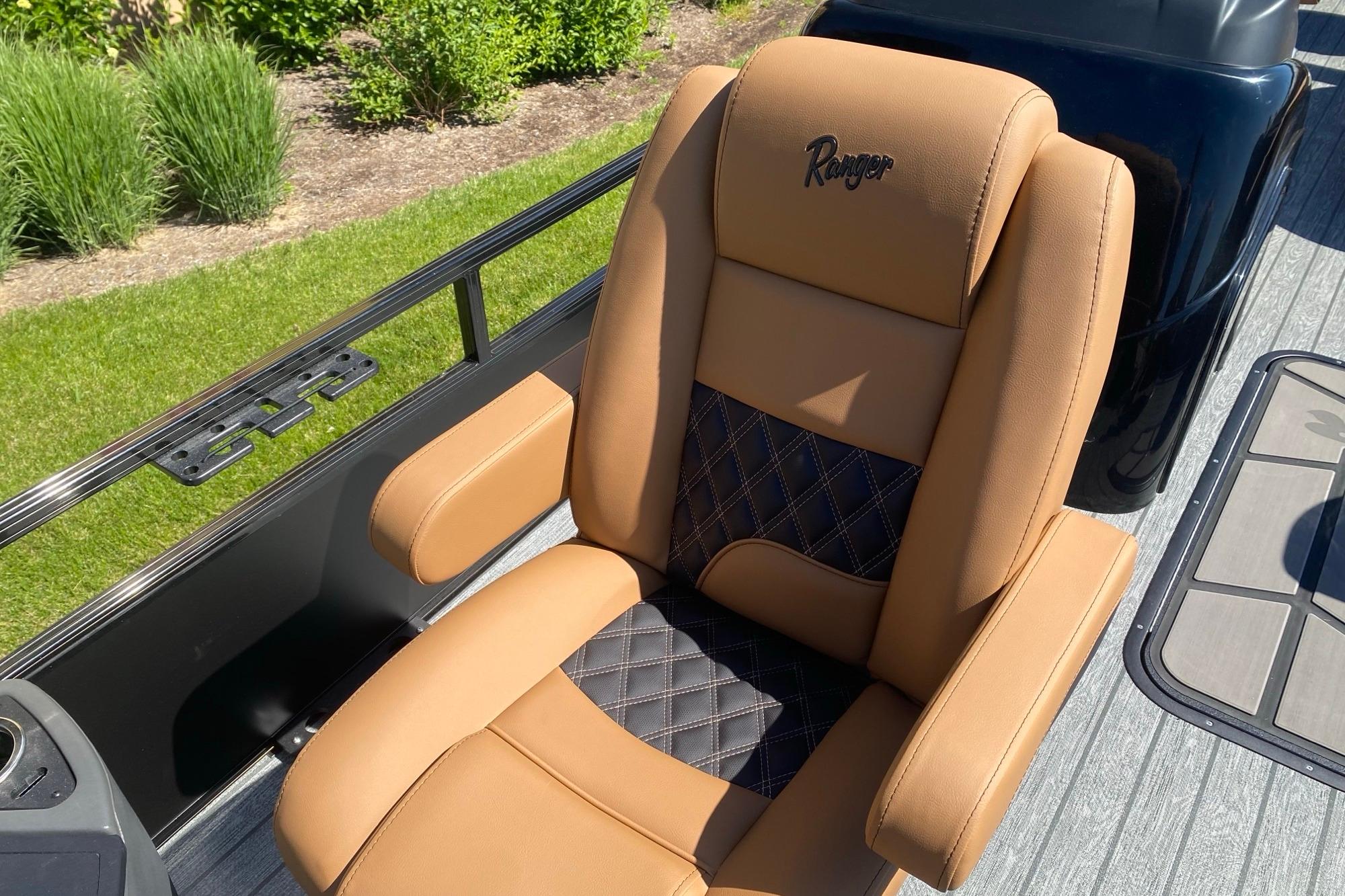 Luxurious tan and black seat on 2026 Ranger 223F boat, featuring diamond stitching.