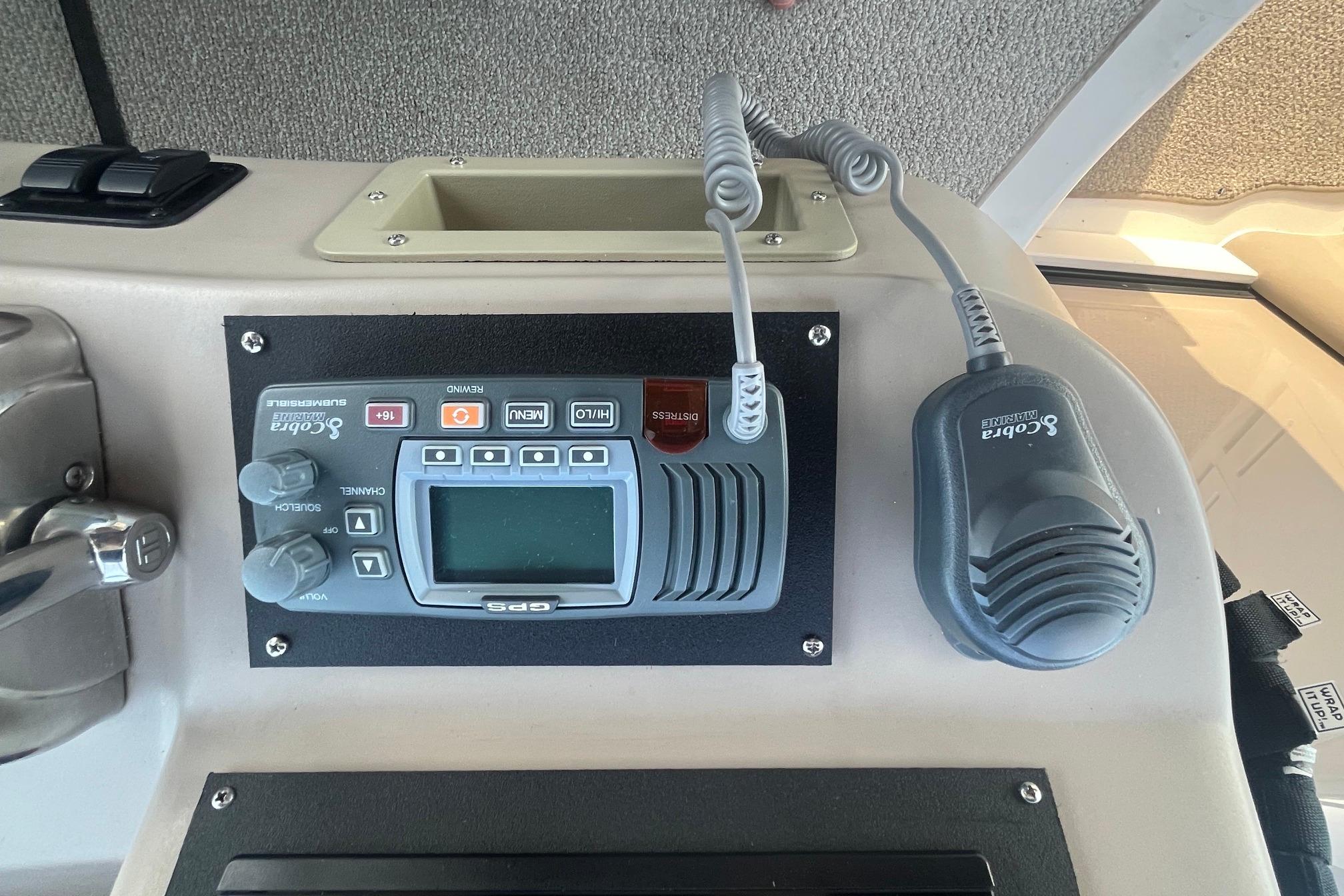 Control panel of a 2001 Sea Ray 340 Sundancer boat with Cobra Marine radio.