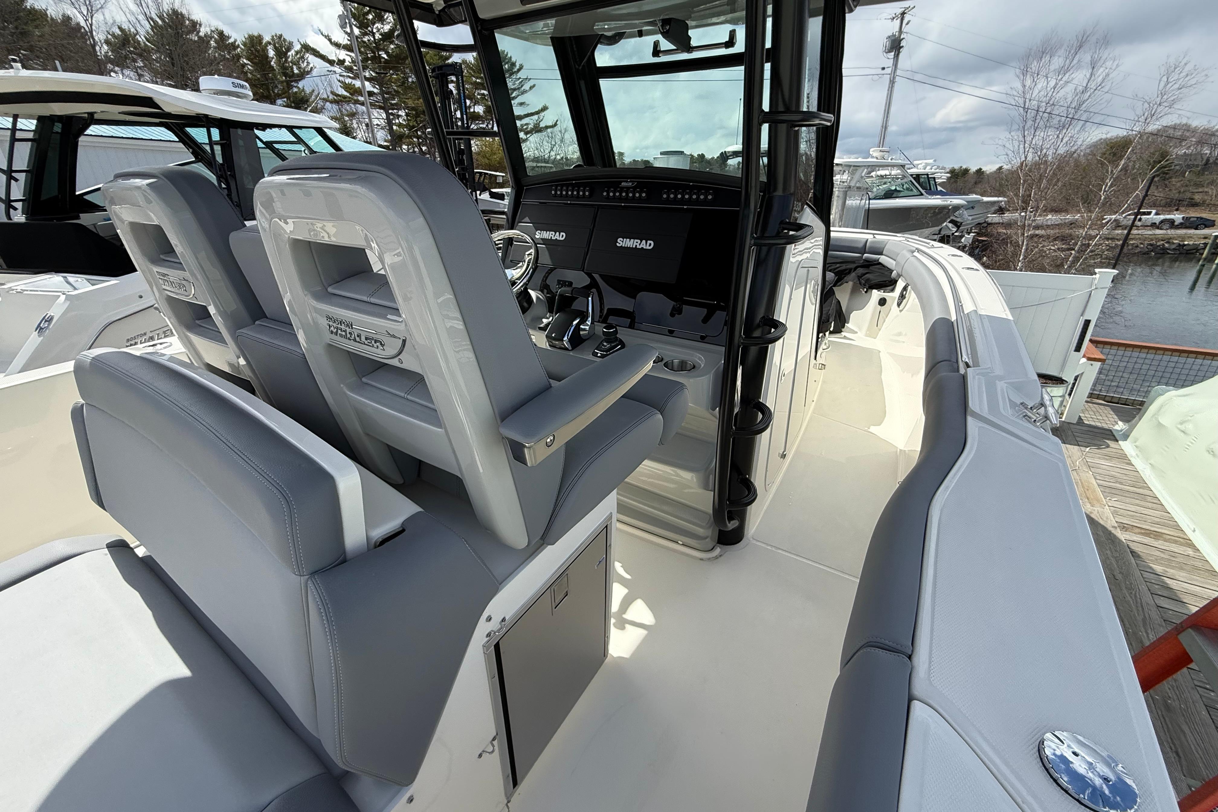 2026 Boston Whaler 330 Outrage boat interior with helm and seating area.
