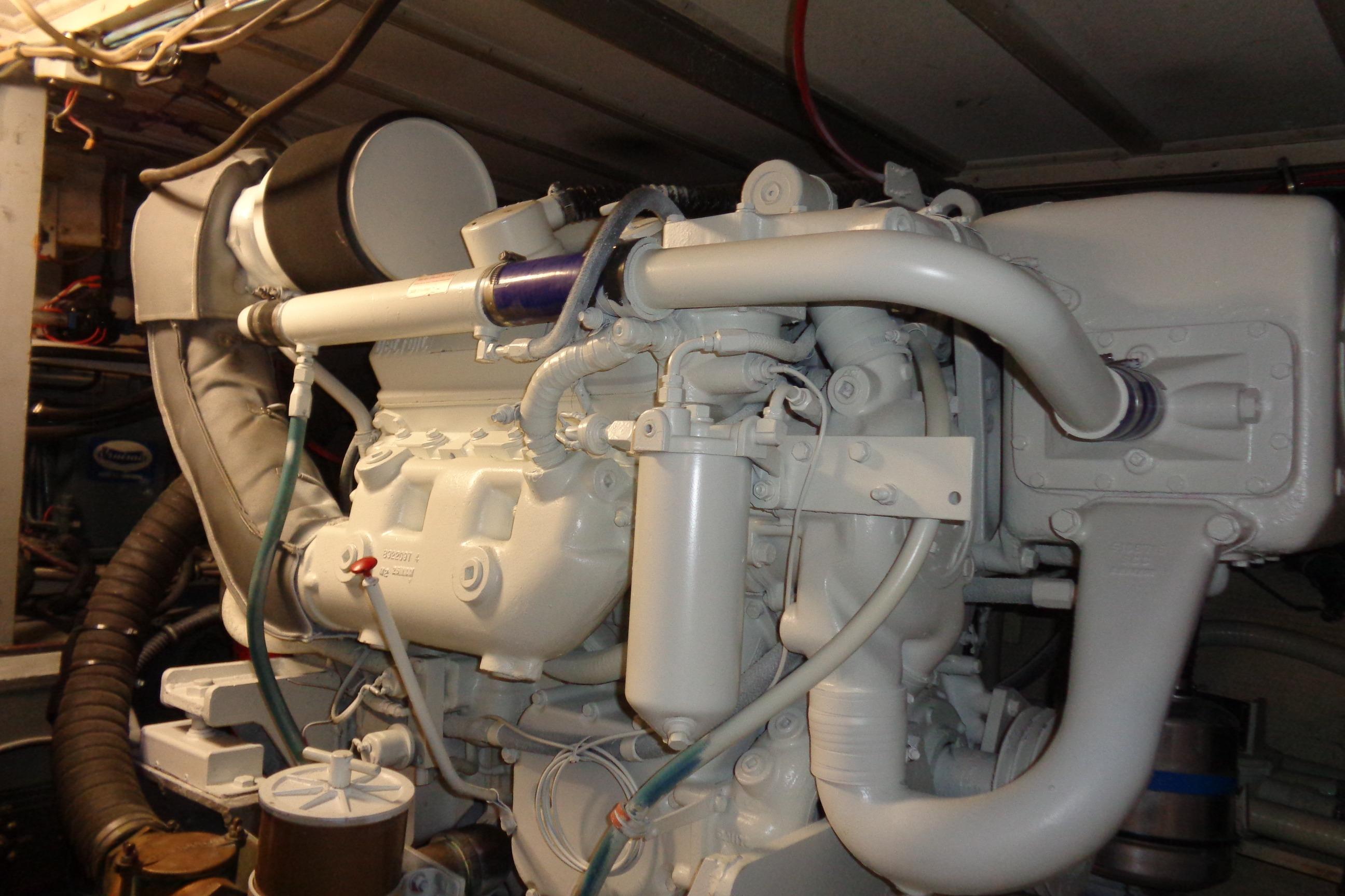 Engine room of 1981 Hatteras 48 Cockpit Motor Yacht, showcasing detailed machinery.
