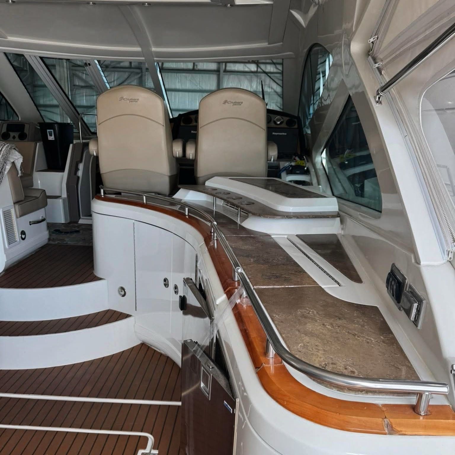 Interior of a 2009 Cruisers Yachts 520 Sports Coupe with sleek seating and wood accents.