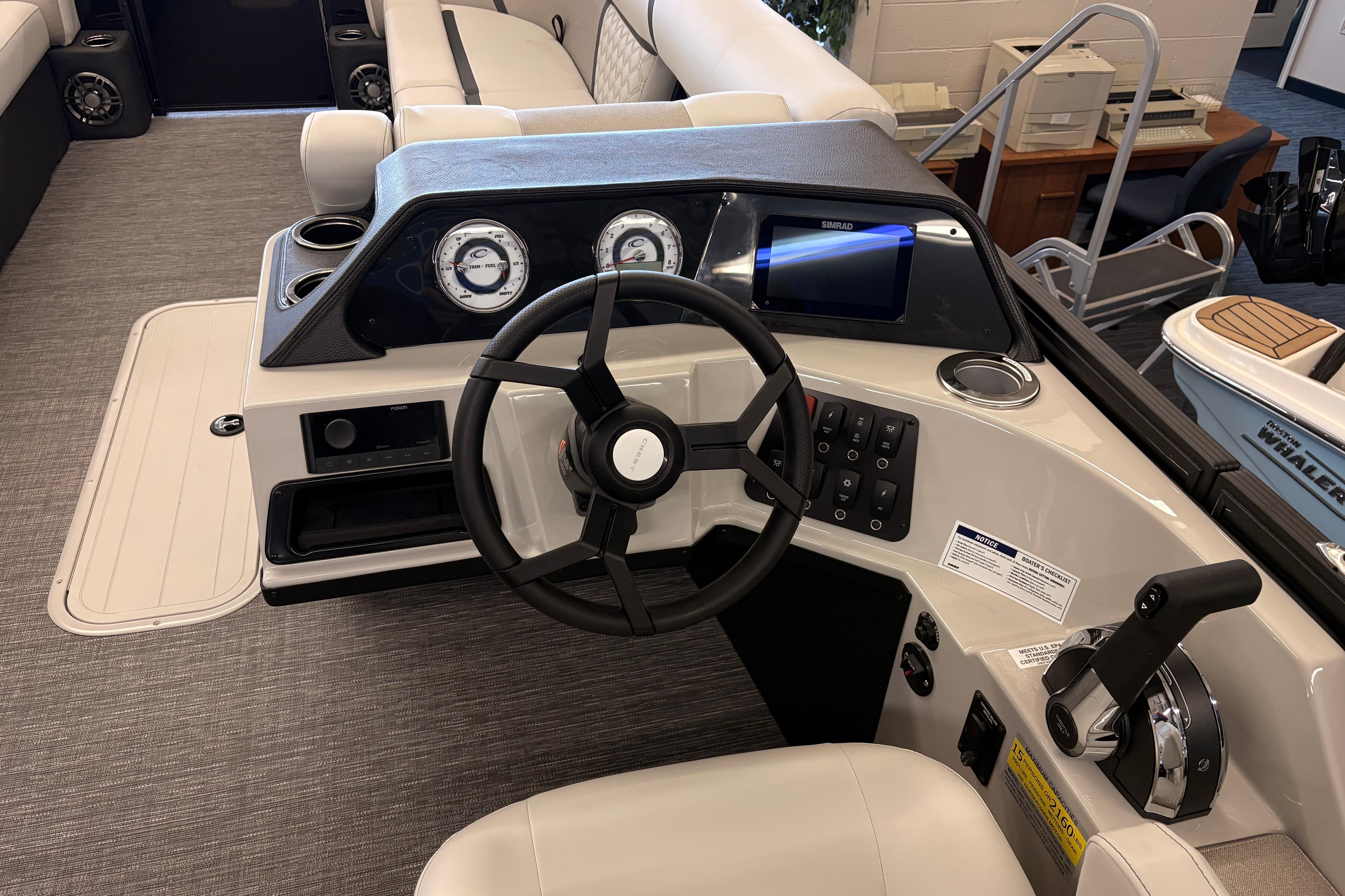 Helm of 2026 Crest Conquest 250 SLSC boat with steering wheel and control panel.