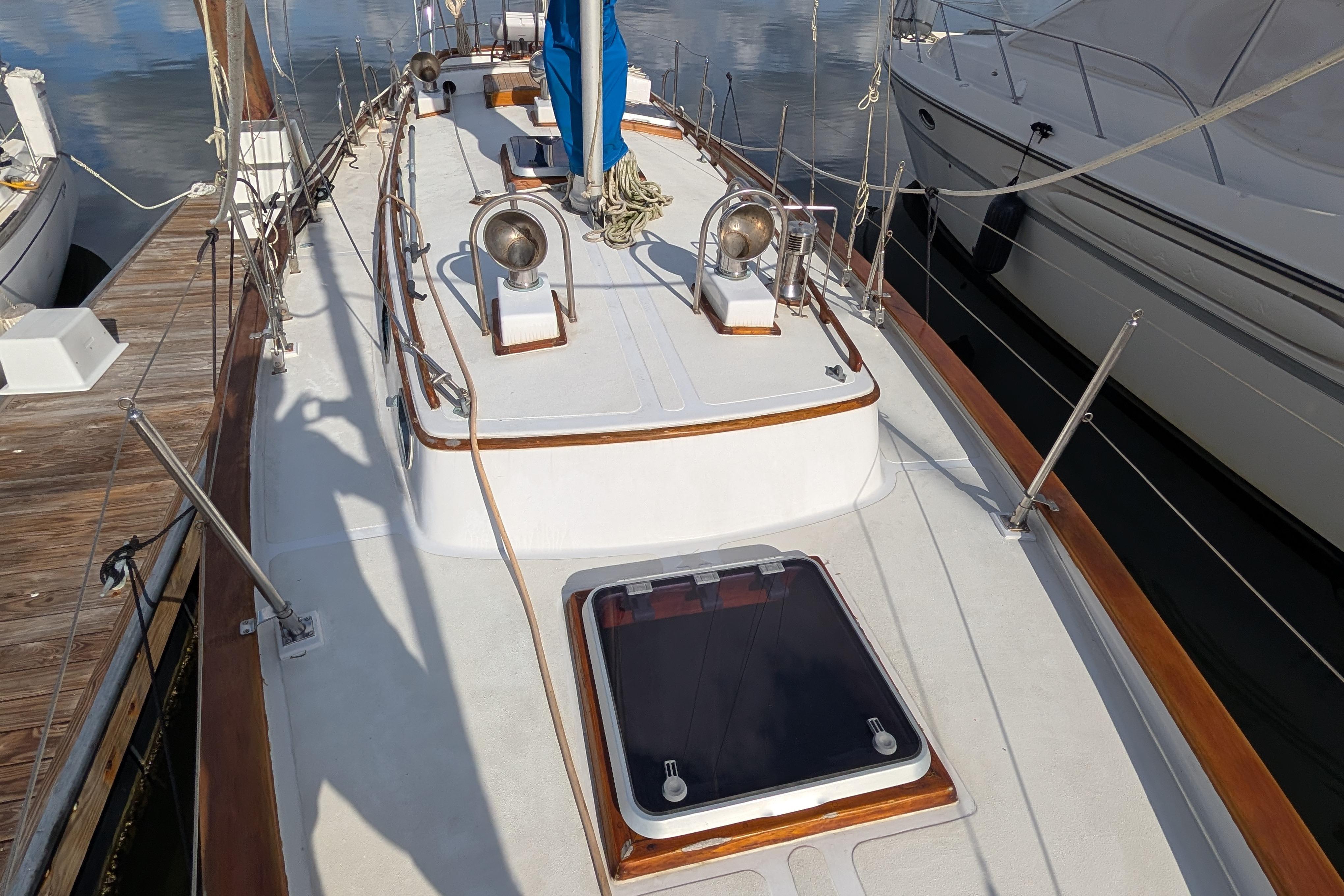 Sailboat deck of 1983 Robert Perry 41, docked with visible hatch and rigging.
