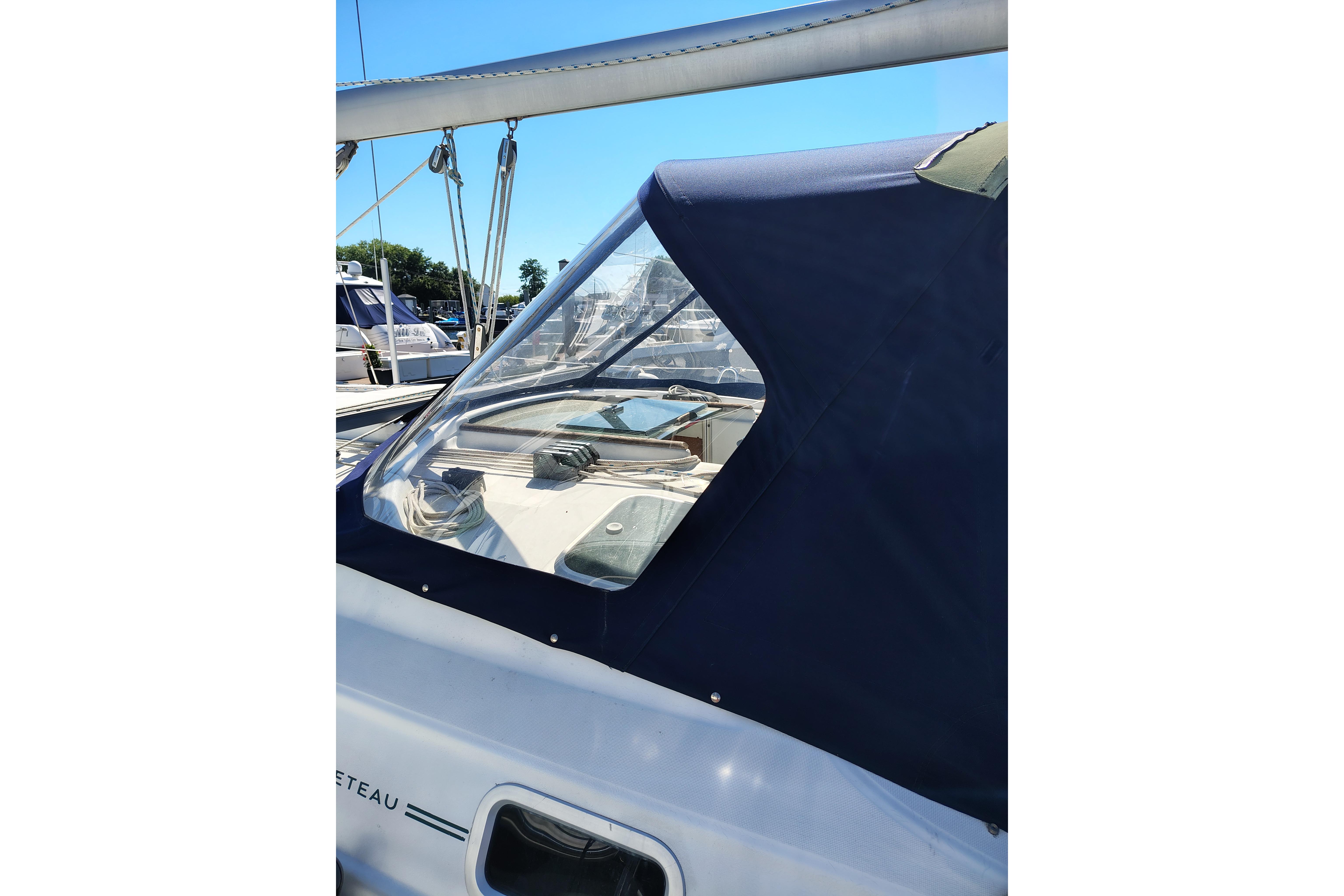 Beneteau Oceanis 411 sailboat cockpit with blue canvas cover, 2001 model.