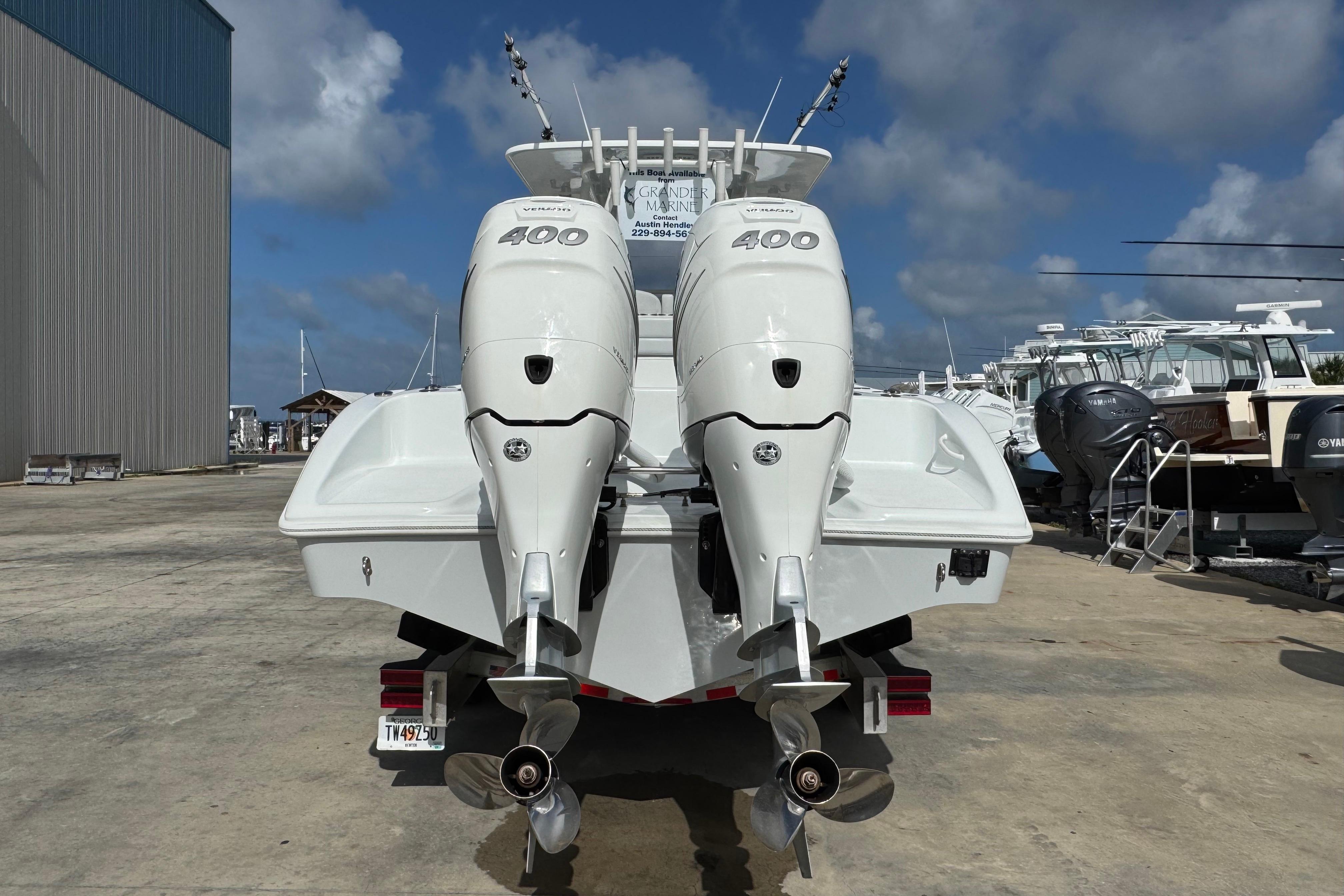 2022 Yellowfin 32 Offshore boat with twin 400 horsepower engines, docked outdoors.