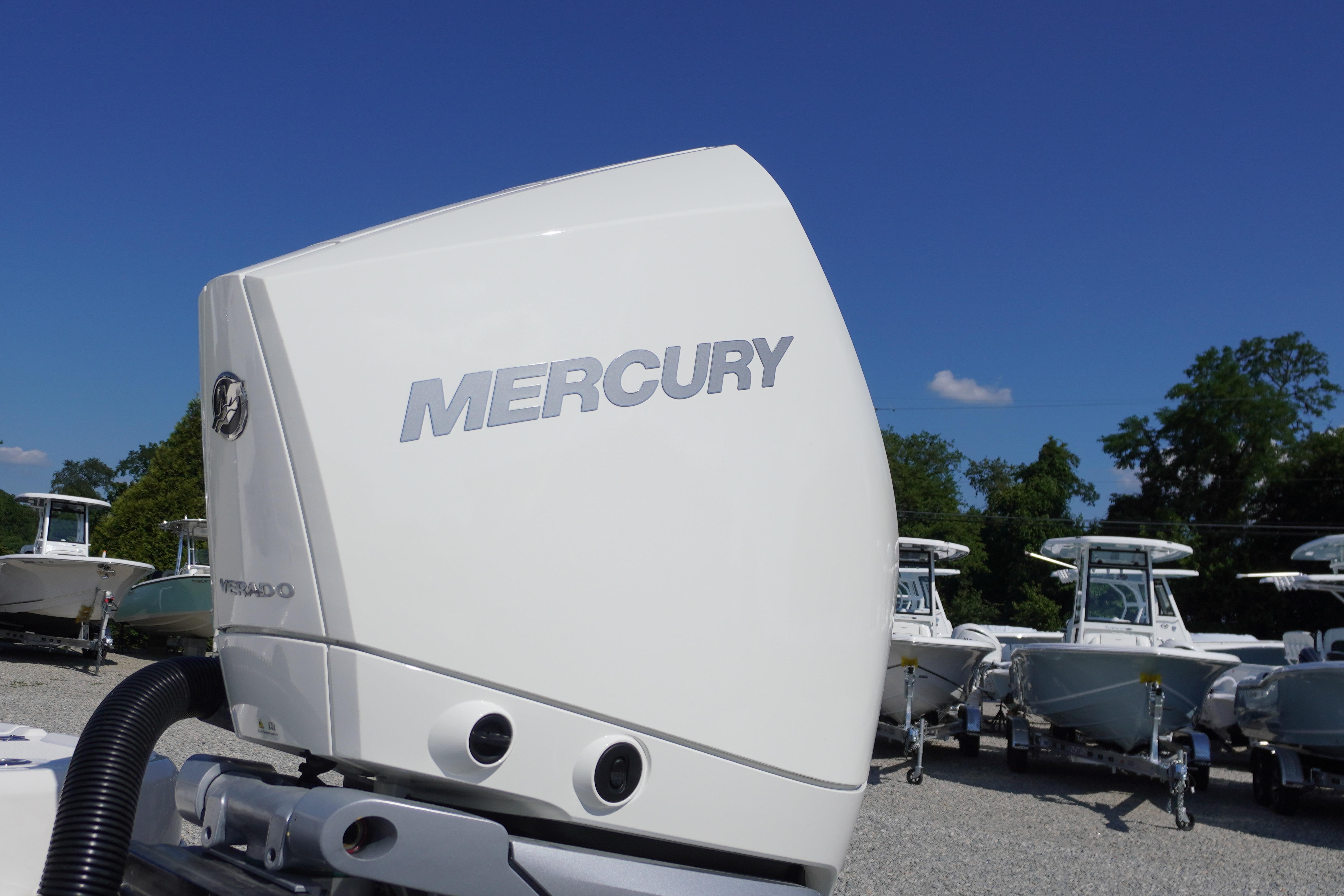 Mercury outboard engine on 2026 Chaparral 270 OSX boat, with clear blue sky background.