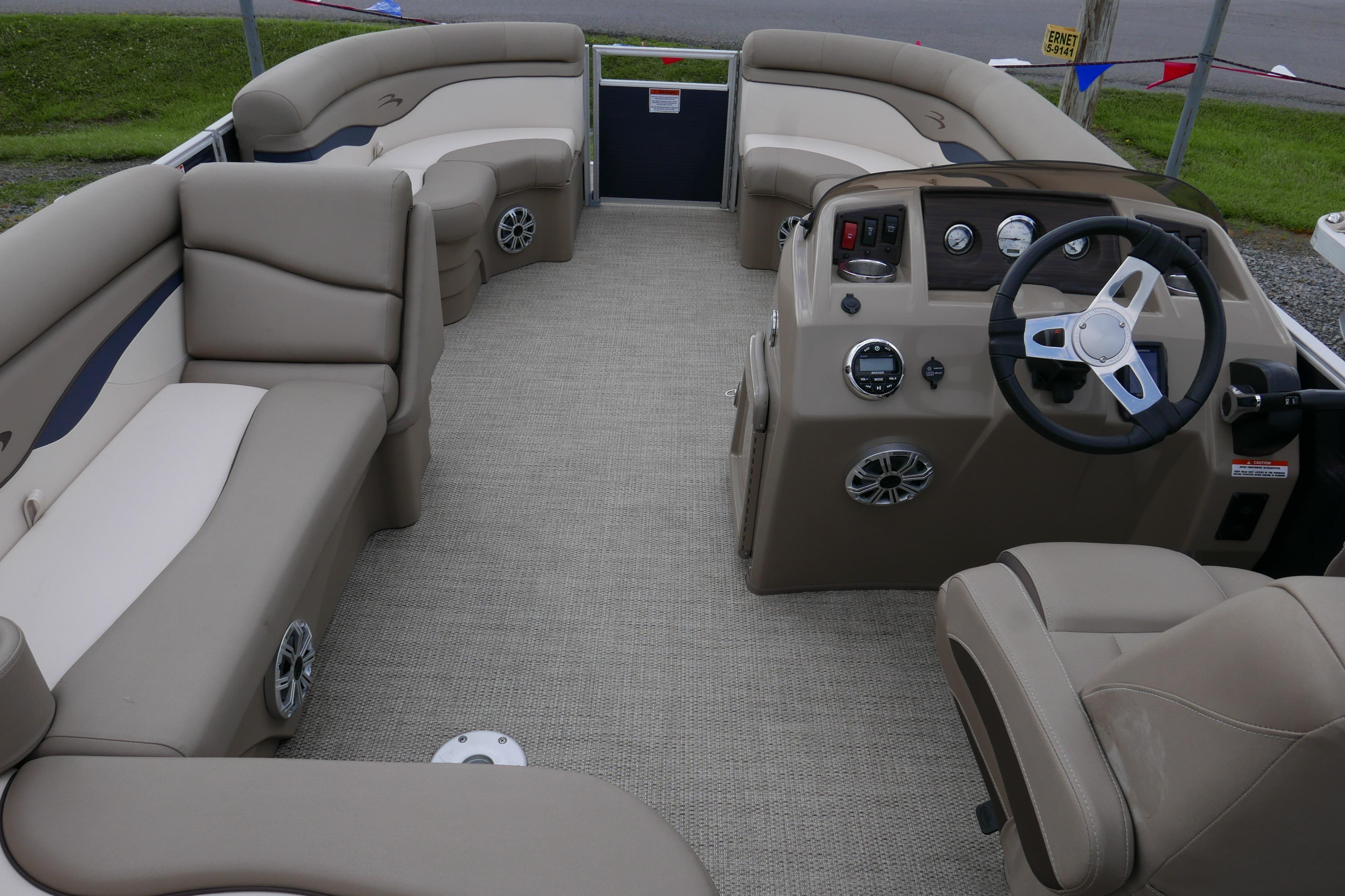 2019 Bennington SX 20 SLXP pontoon boat interior with beige seating and steering console.