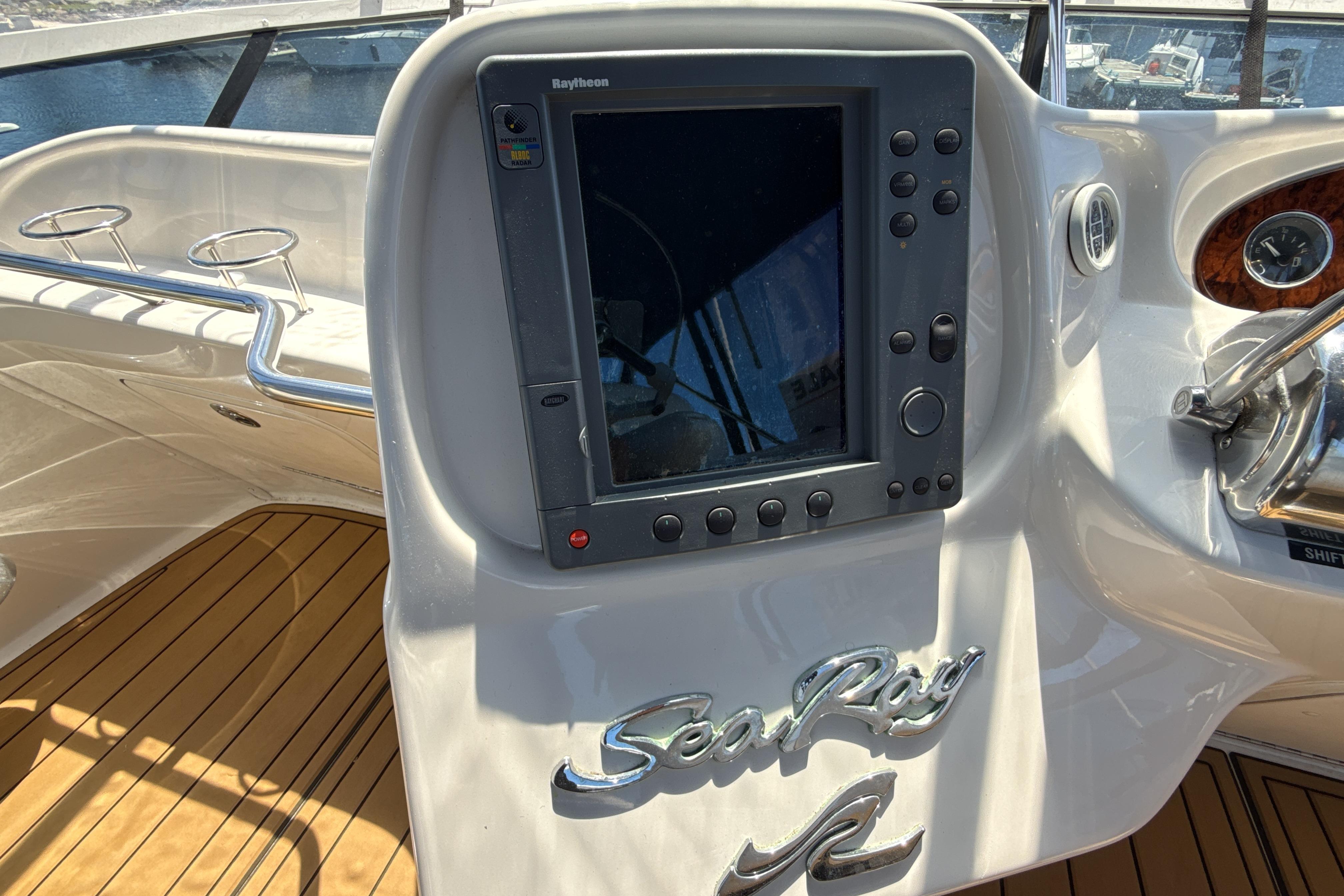 Control panel of a 2001 Sea Ray 400 Sedan Bridge yacht with Raytheon display.