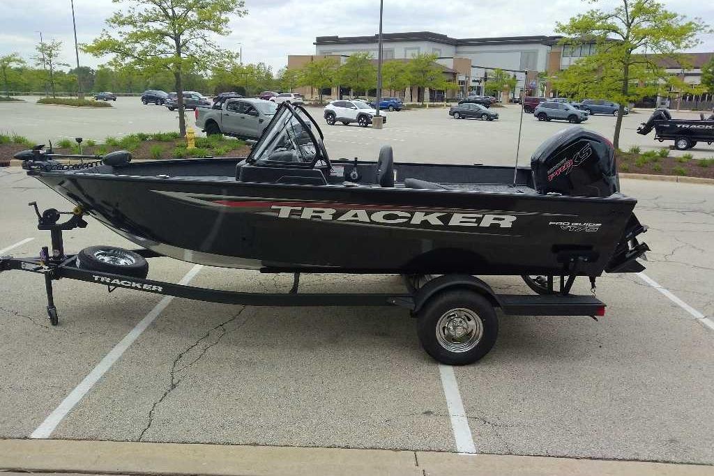 2026 Tracker Pro Guide V-175 Combo boat on trailer in parking lot.