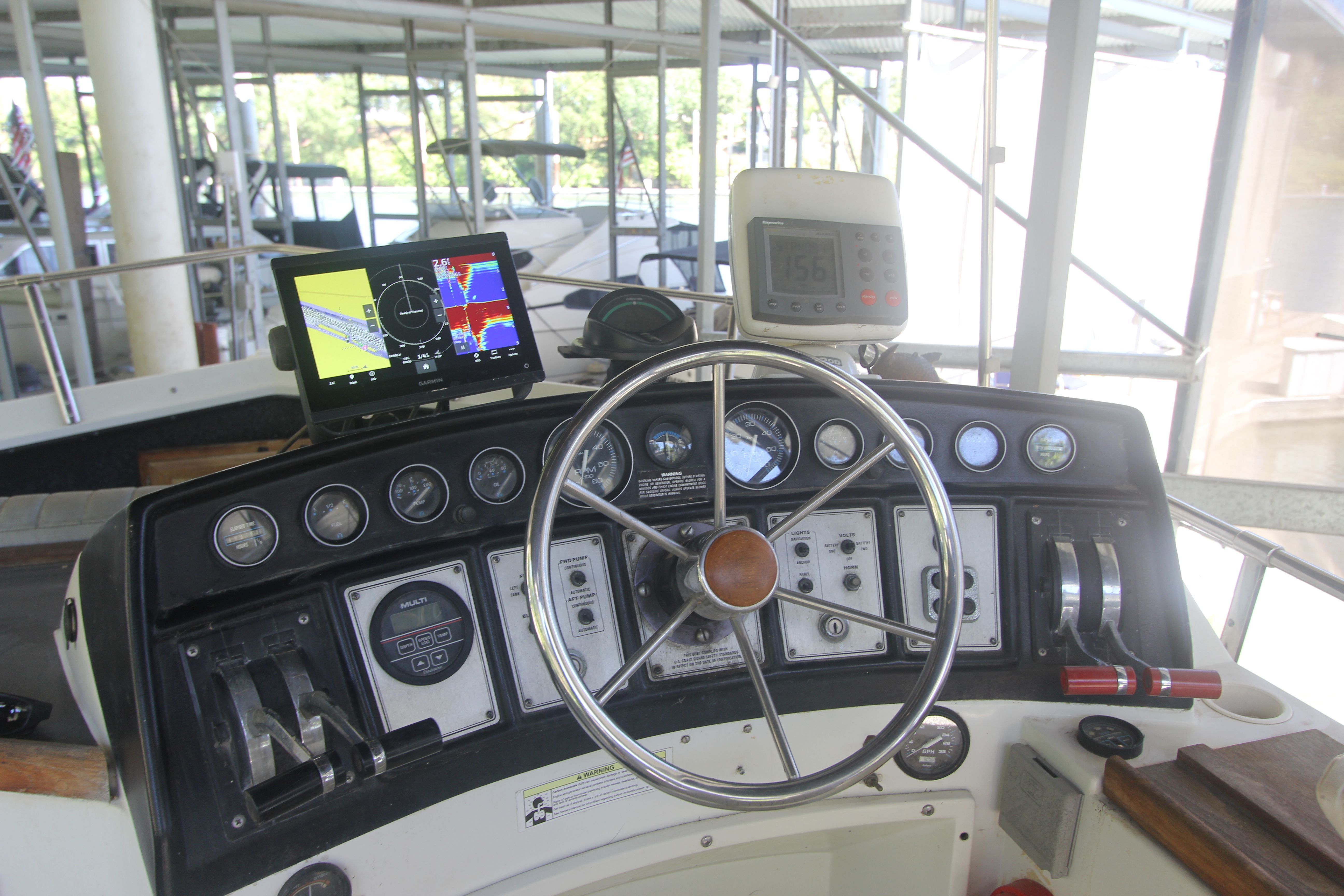 Helm of a 1988 Carver 3607 Aft Cabin Motor Yacht with navigation equipment.
