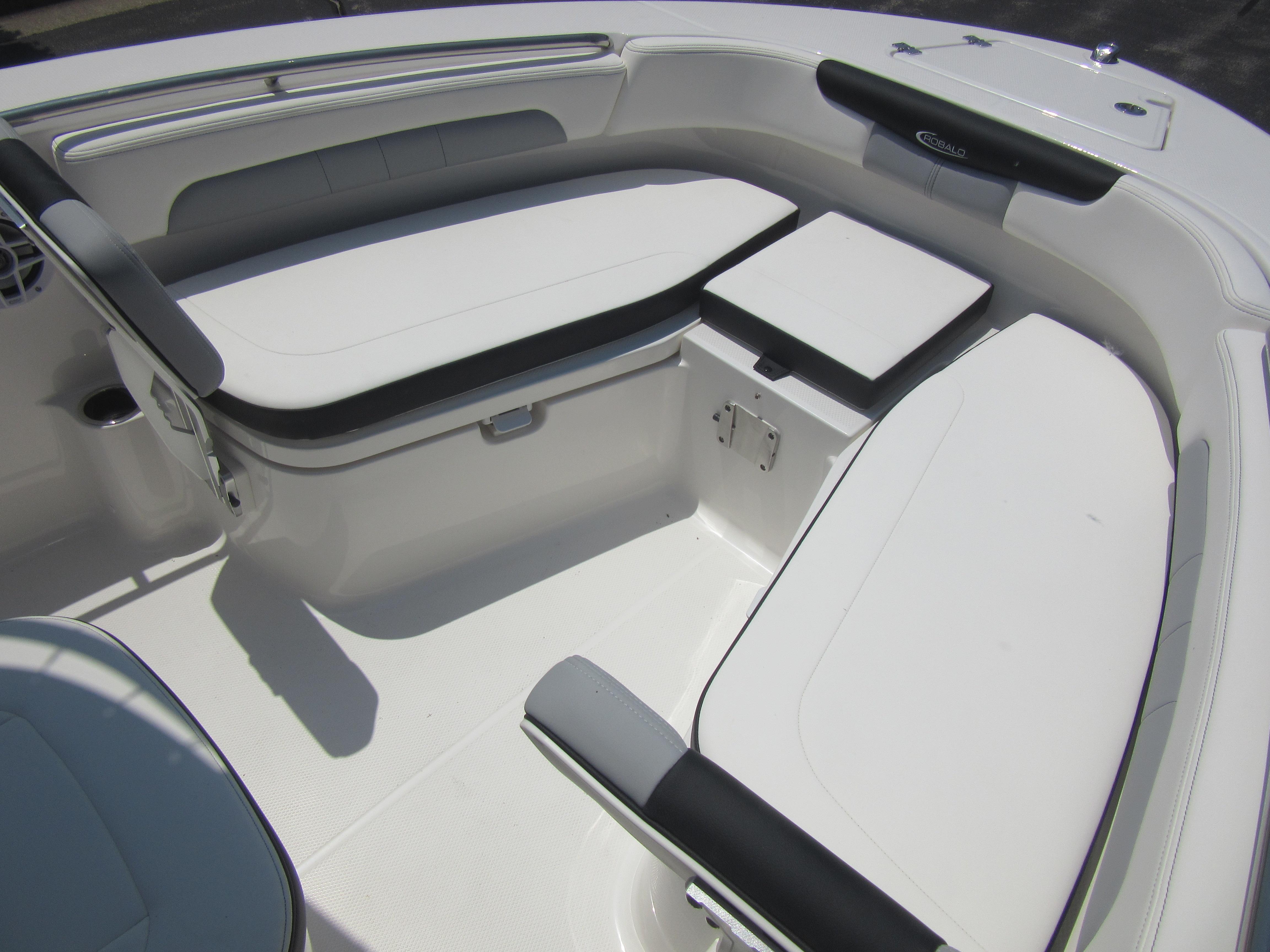 2025 Robalo R202 Explorer boat interior with cushioned seating and storage compartments.