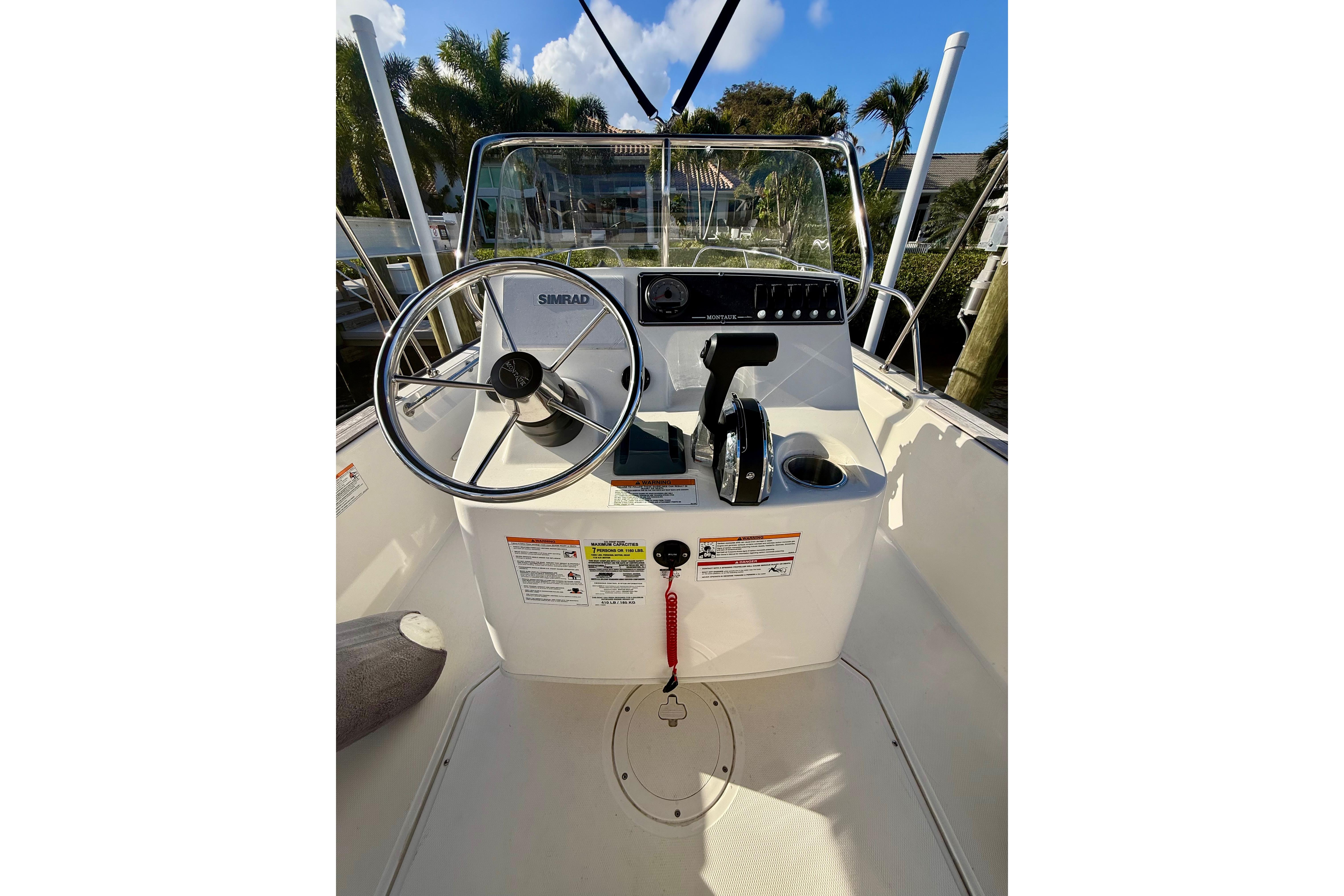 2025 Boston Whaler 170 Montauk boat console with steering wheel and controls.