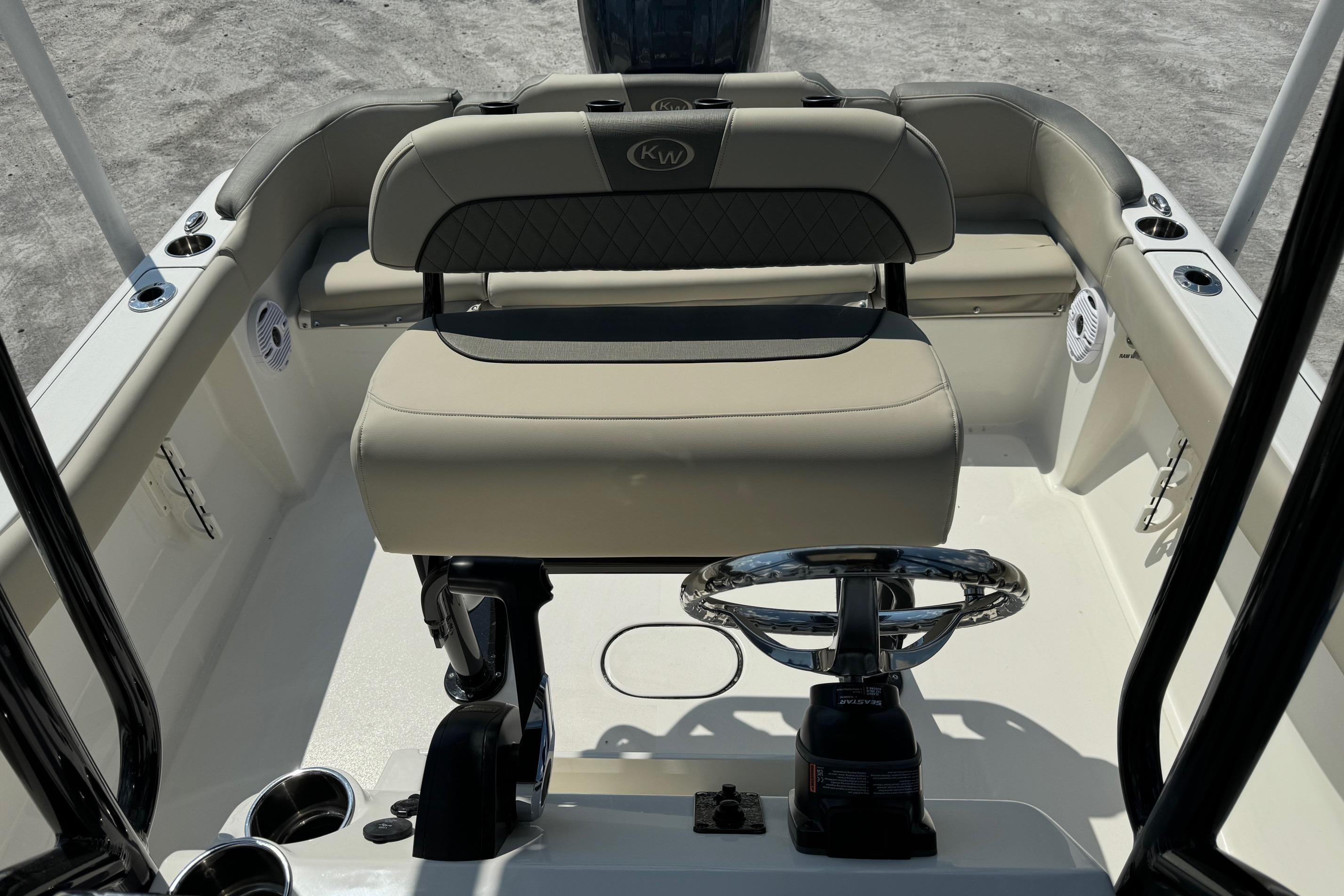 2025 Key West 203 FS boat interior with steering wheel and seating.