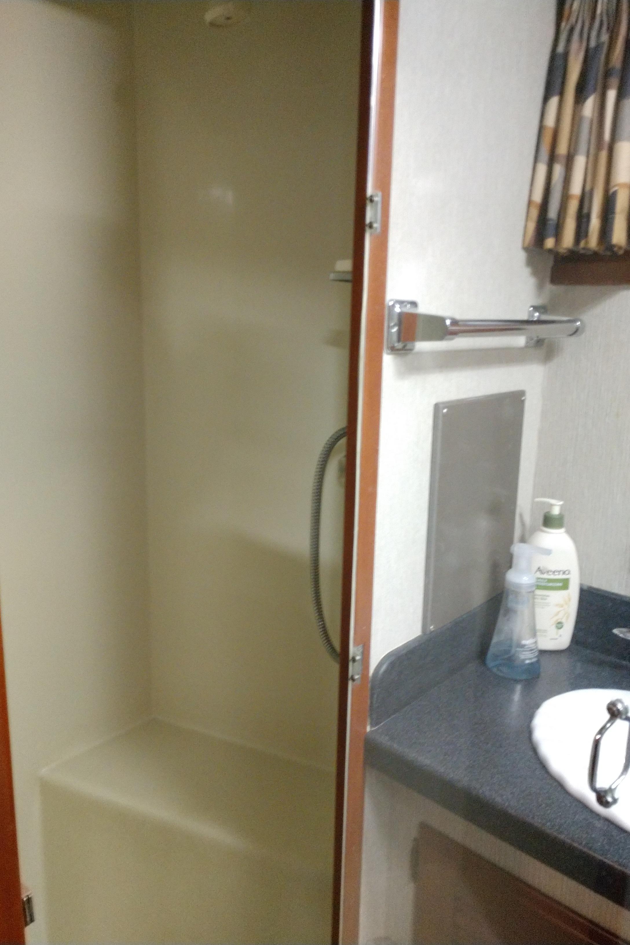 1981 Tollycraft 43 Motoryacht bathroom with shower, sink, and toiletries.