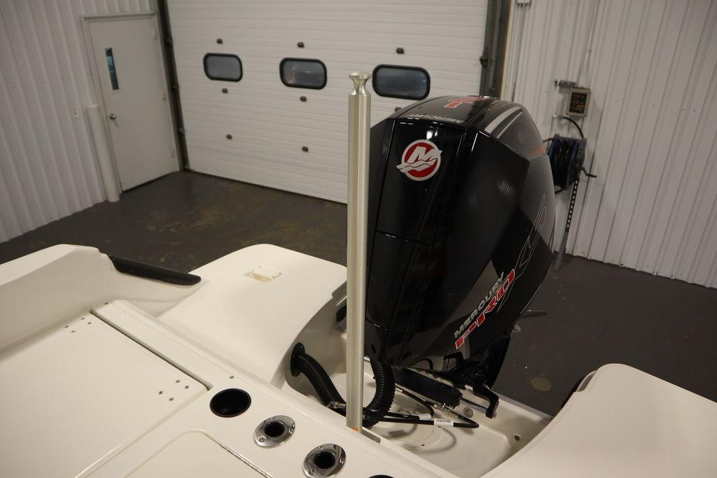 2026 Bayliner Trophy T20CC boat with Mercury outboard motor in a garage.