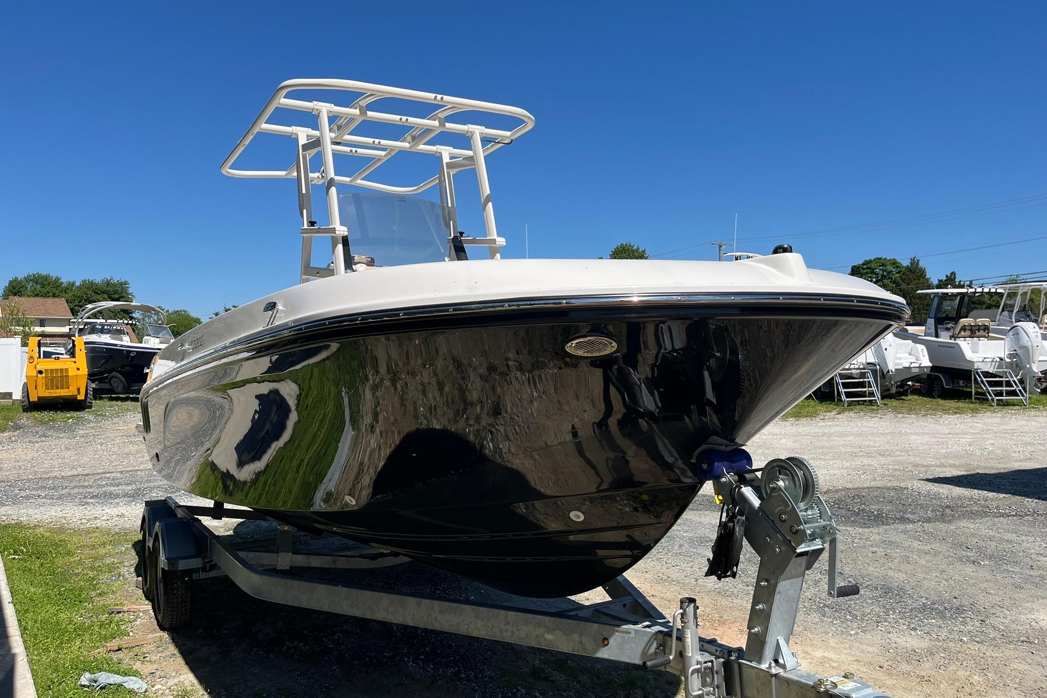2026 Bayliner Trophy T22CC boat on trailer under clear blue sky.