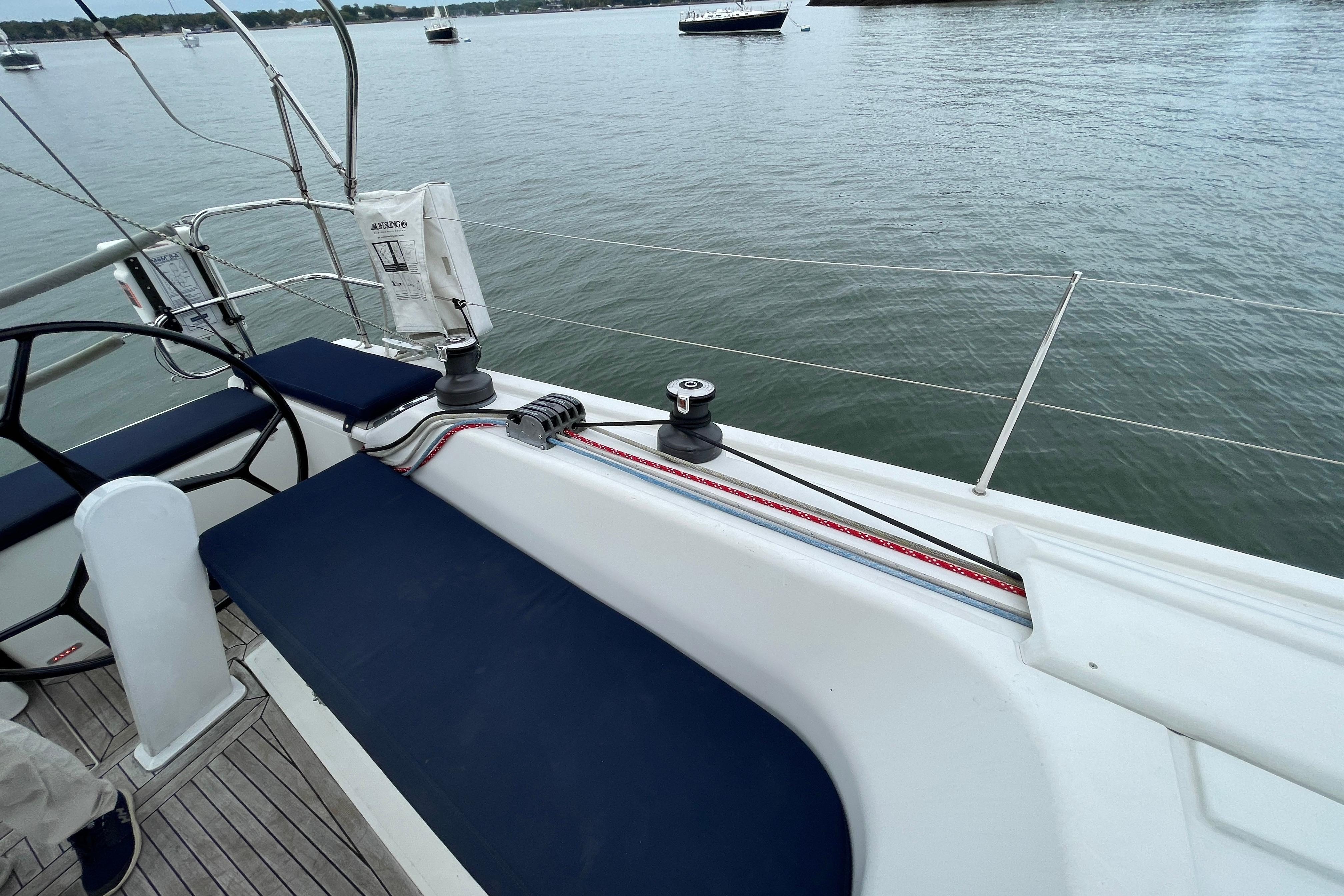 2014 Hanse 415 sailboat deck with seating and winch, overlooking calm waters.