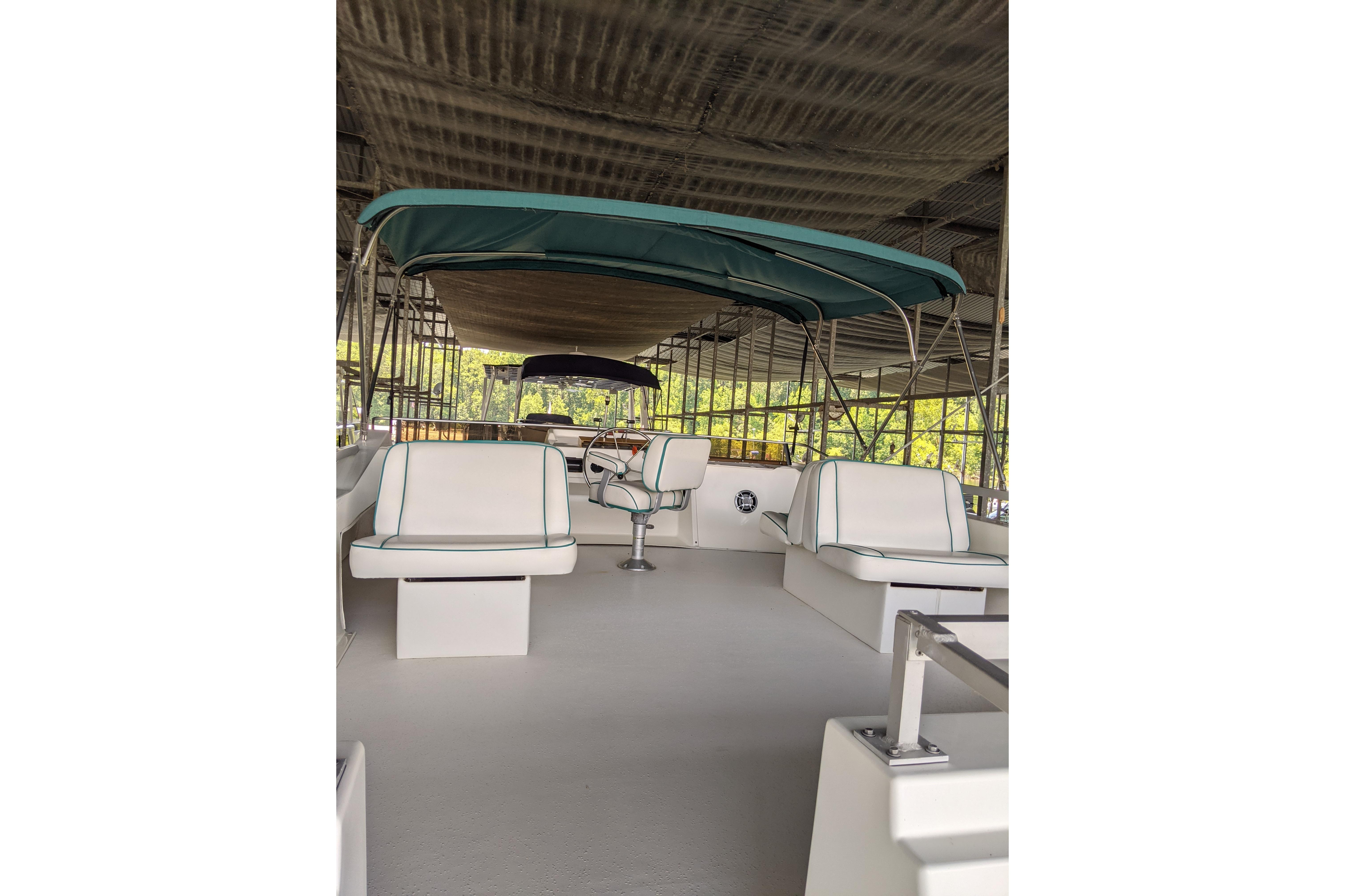 2001 Gibson 50 Cabin Yacht interior with seating and canopy under a covered dock.