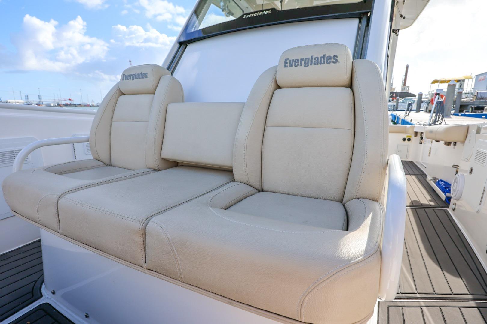 2017 Everglades 355 Center Console boat with beige seating, docked under a blue sky.